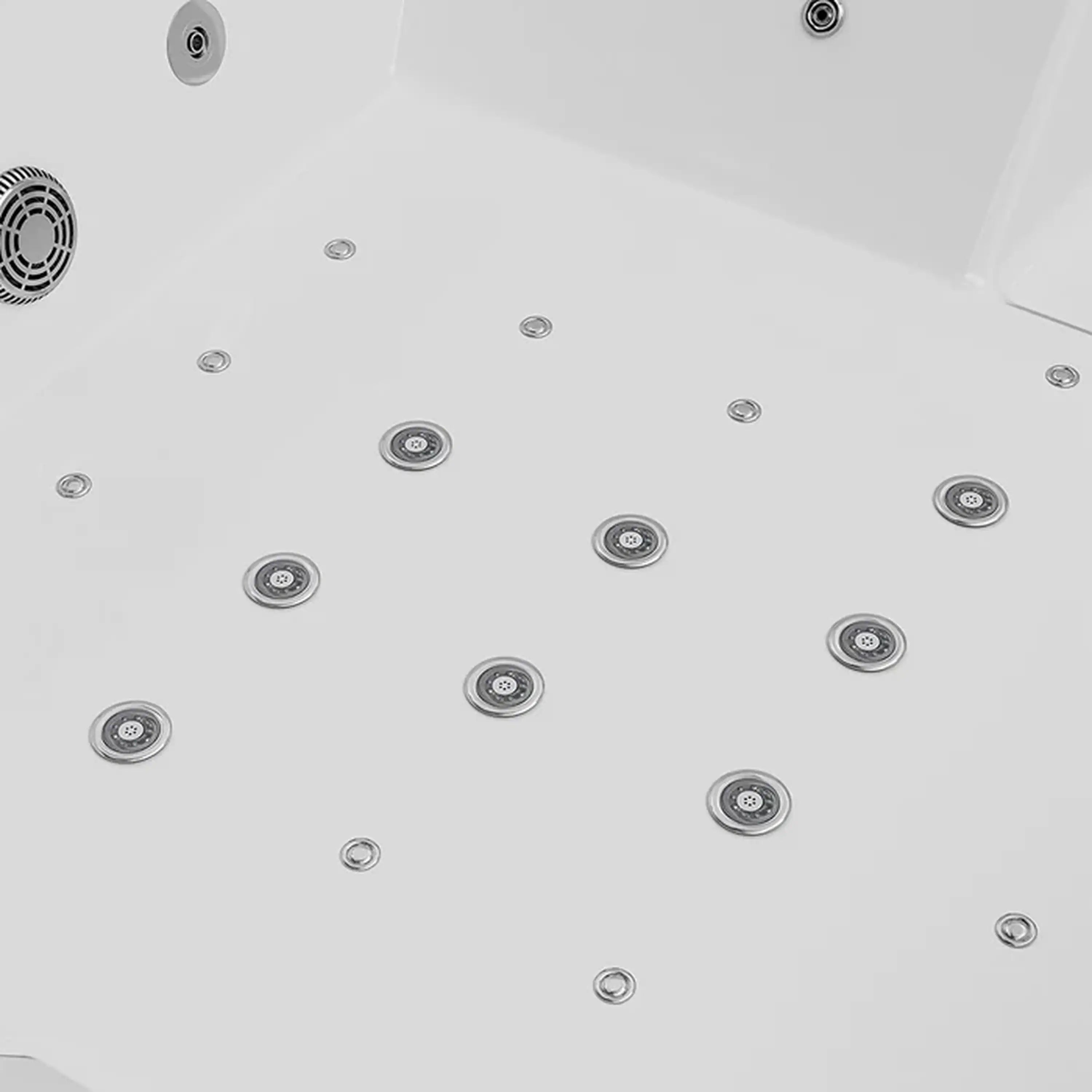 Close-up of chrome massage jet nozzles on the base of a white whirlpool tub