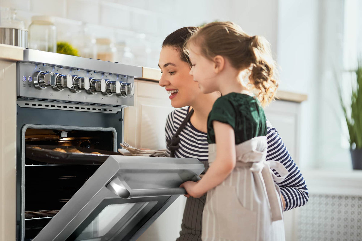 Stainless steel gas range with open oven door and front control knobs