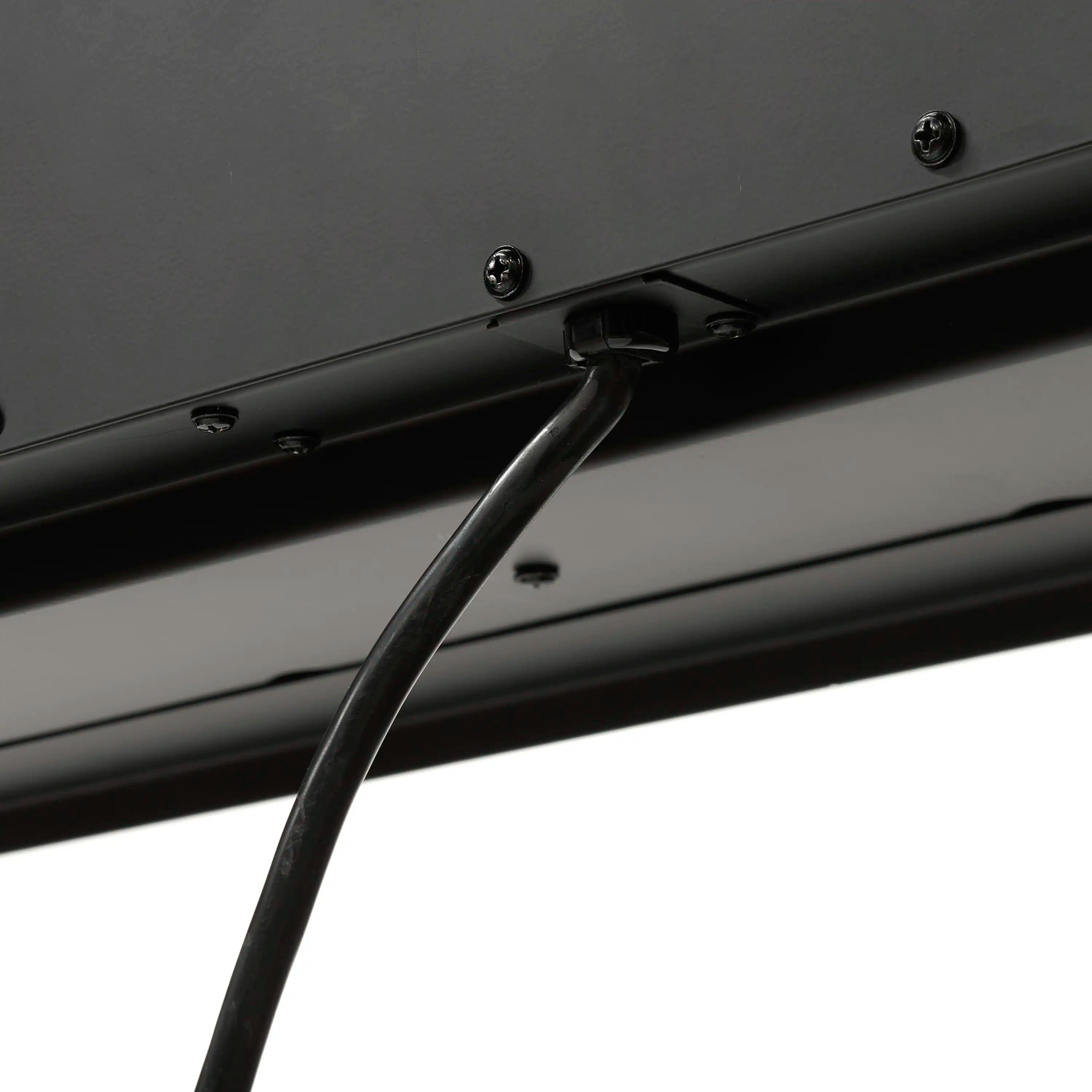 Electric fireplace power cord connected to the underside with visible screws