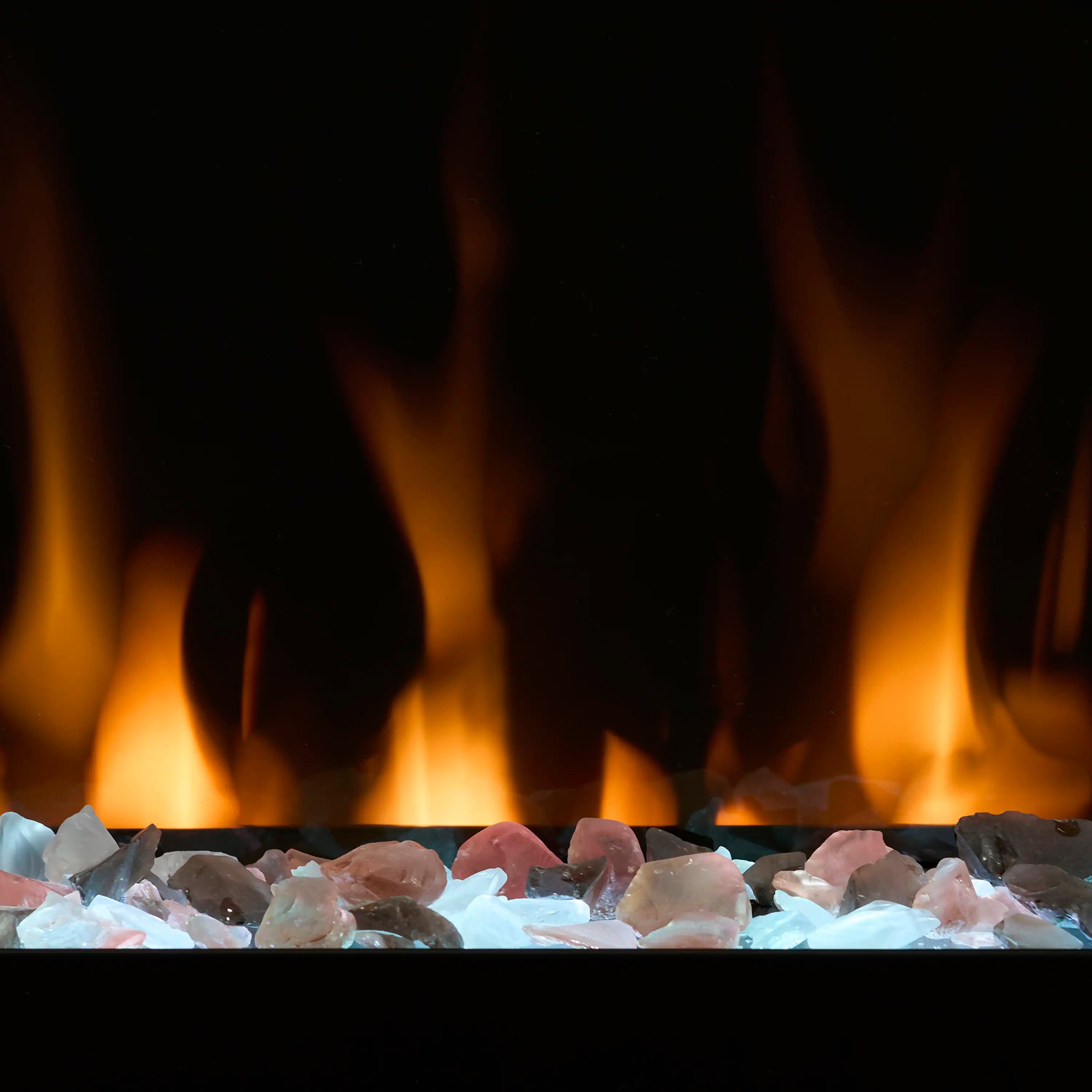 Electric fireplace ember bed with mixed blue and clear rocks and tall orange flames