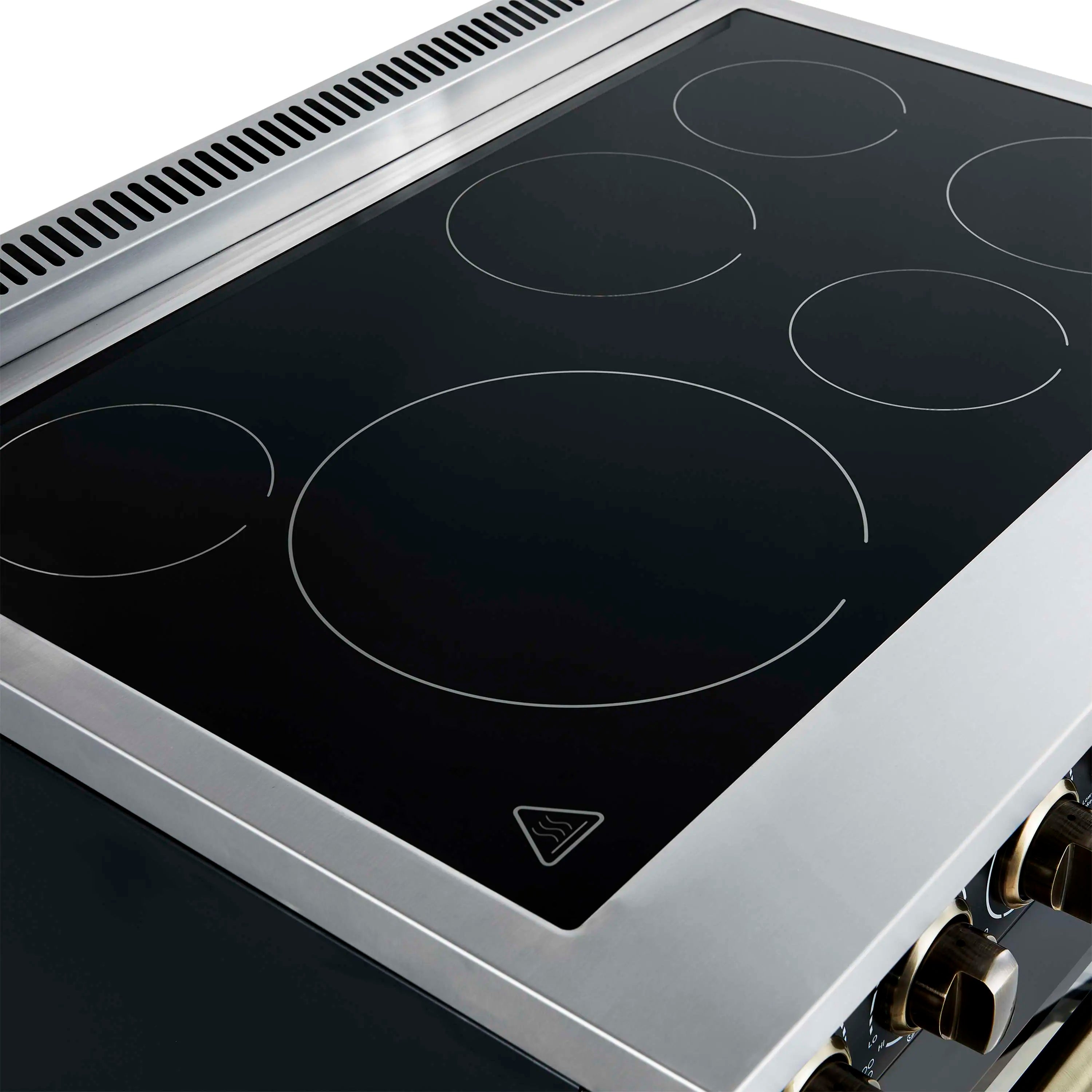 Close-up of black glass cooktop with circular burner markings and vent trim