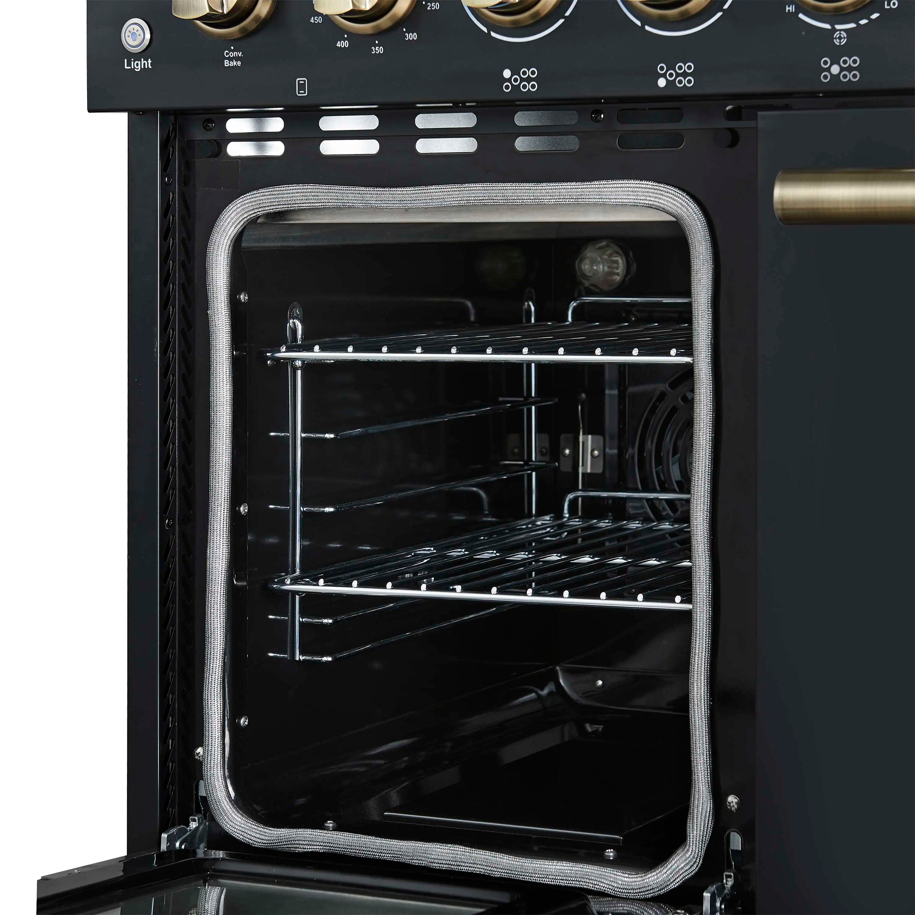 Electric oven interior with wire racks and black enamel walls