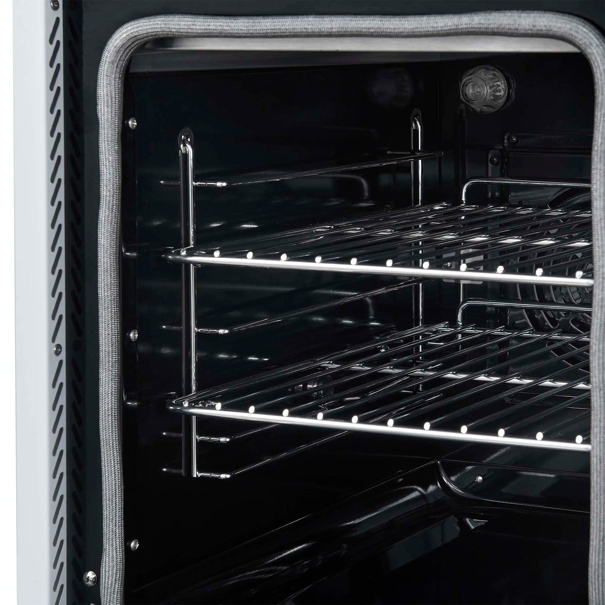 Convection oven interior close-up with wire racks and dark back panel