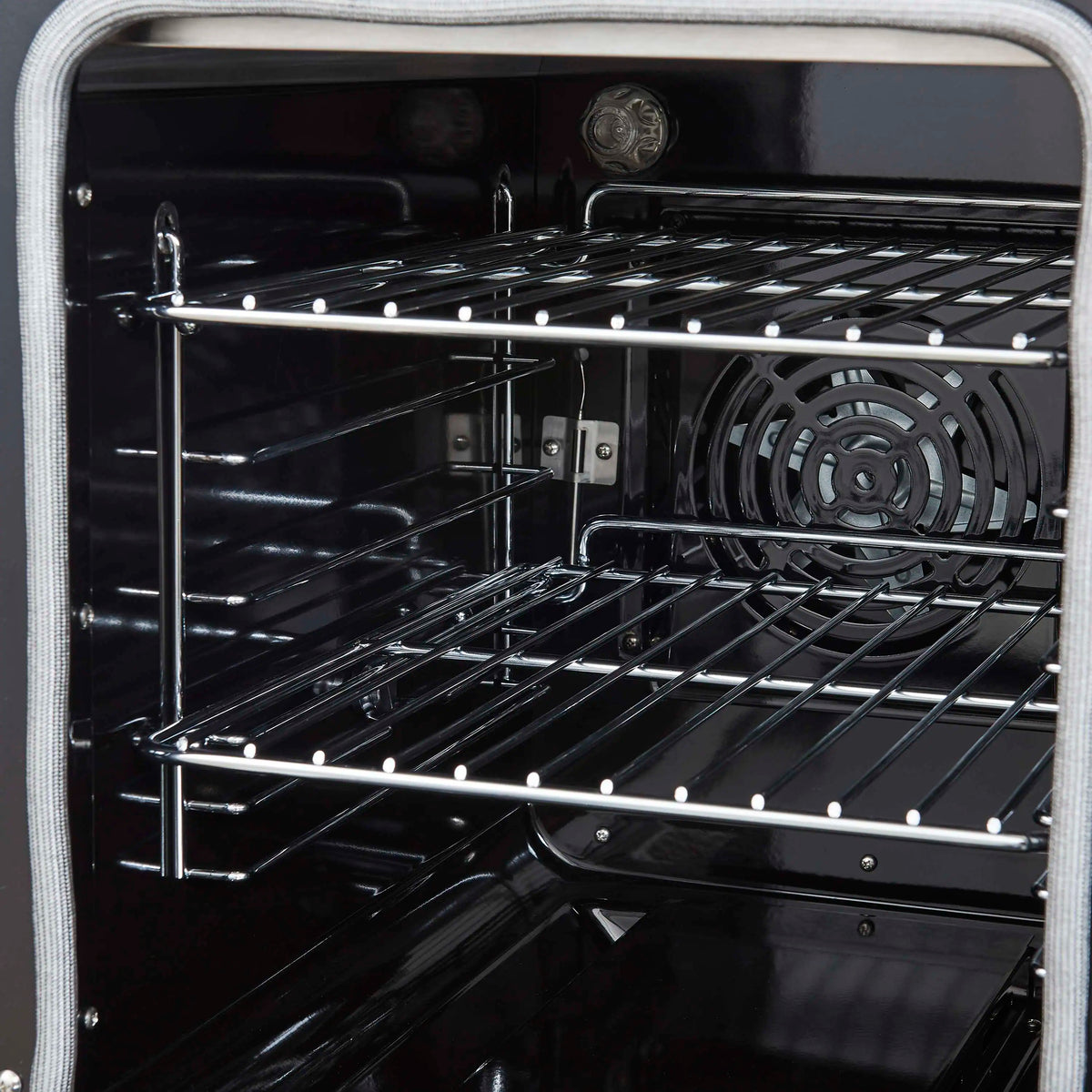 Freestanding electric range oven with wire rack and visible convection fan