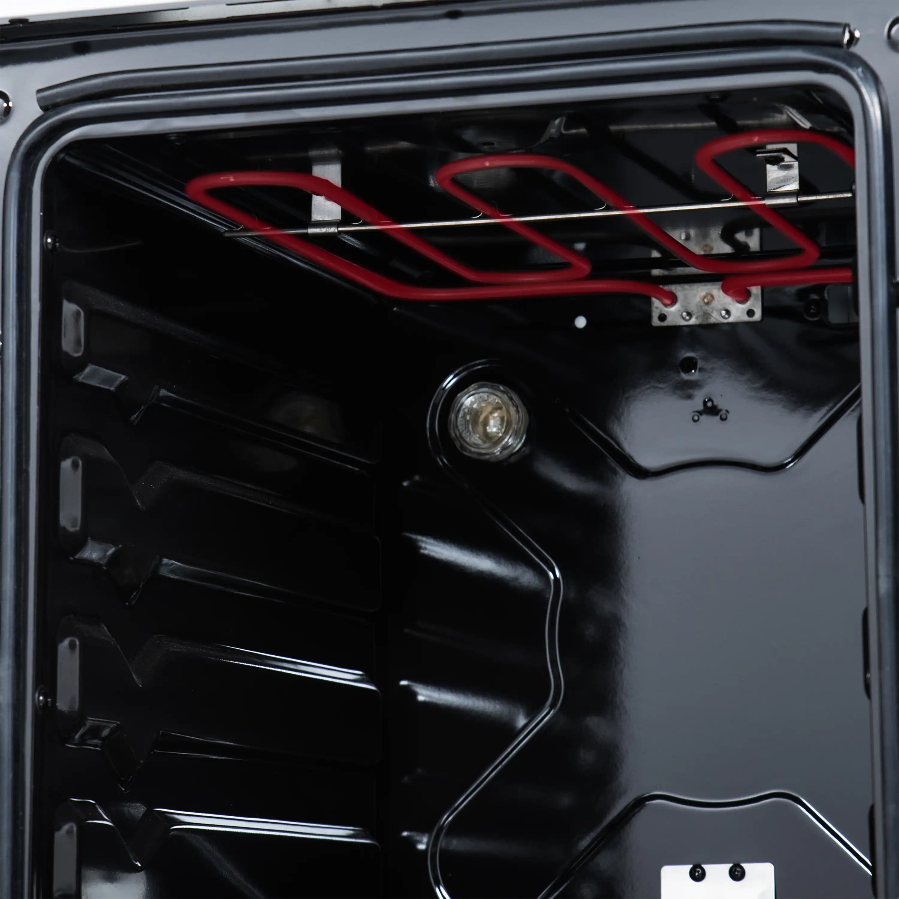Freestanding electric range oven door interior with racks and heating elements, dark cavity