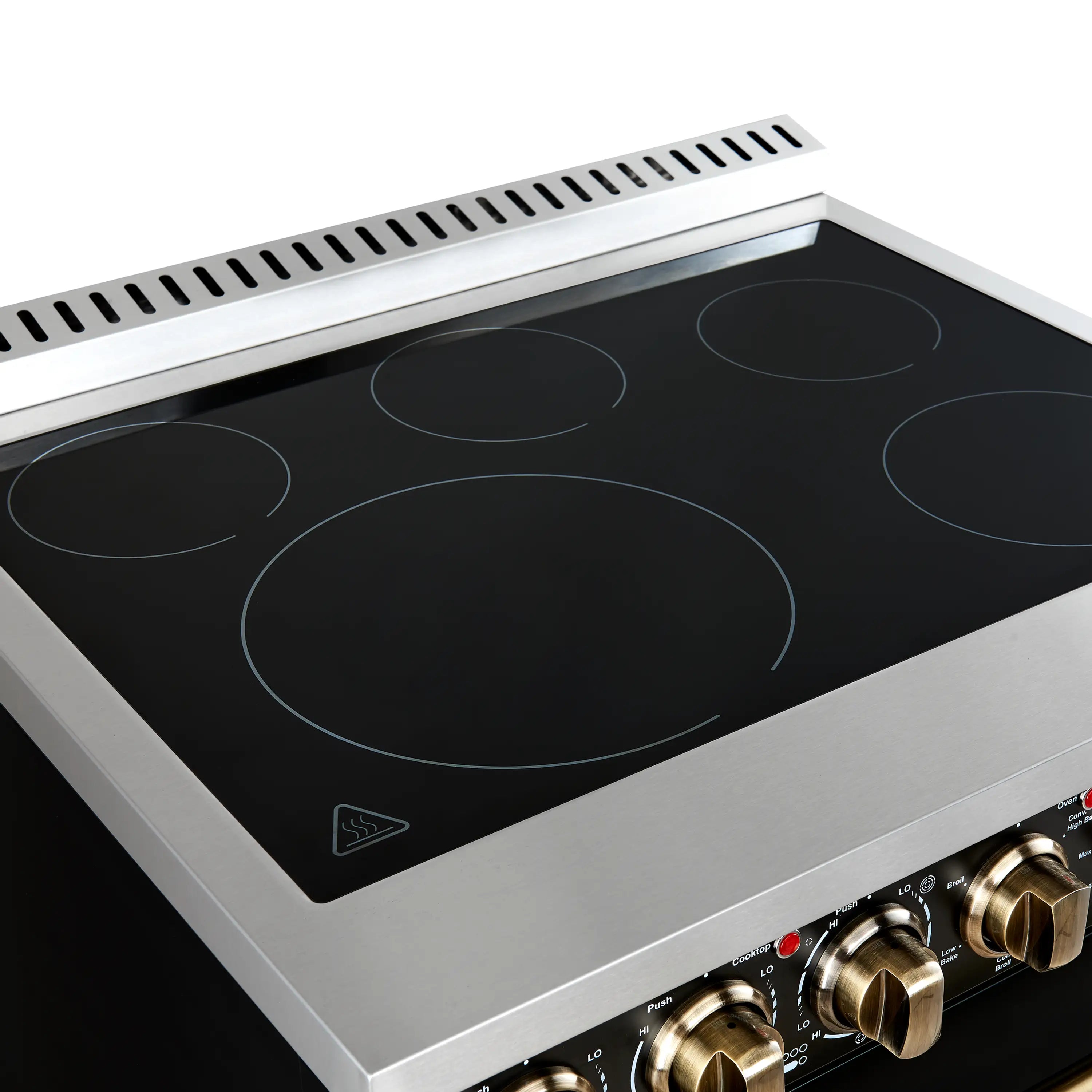 Black glass cooktop with four radiant zones and antique brass control knobs.