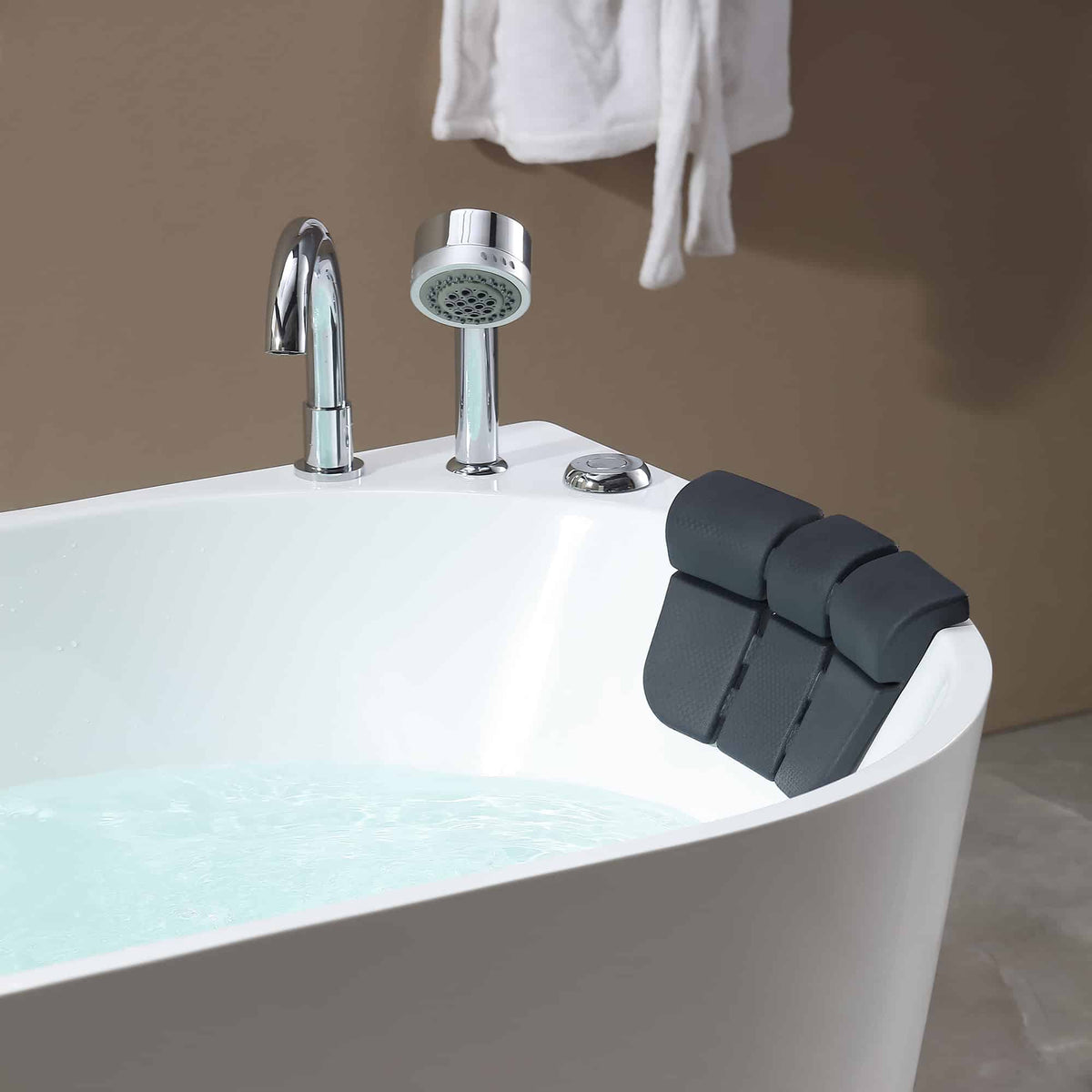 White whirlpool bathtub rim with chrome faucet and mounted black adjustable headrest