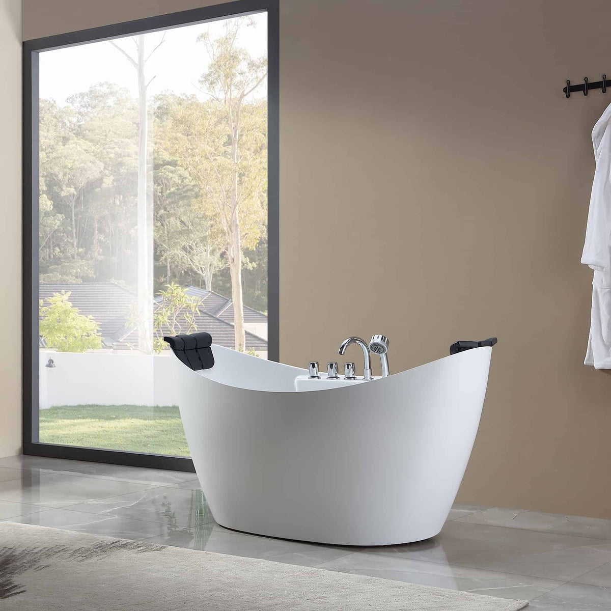 White freestanding acrylic bathtub with chrome faucet and black headrests