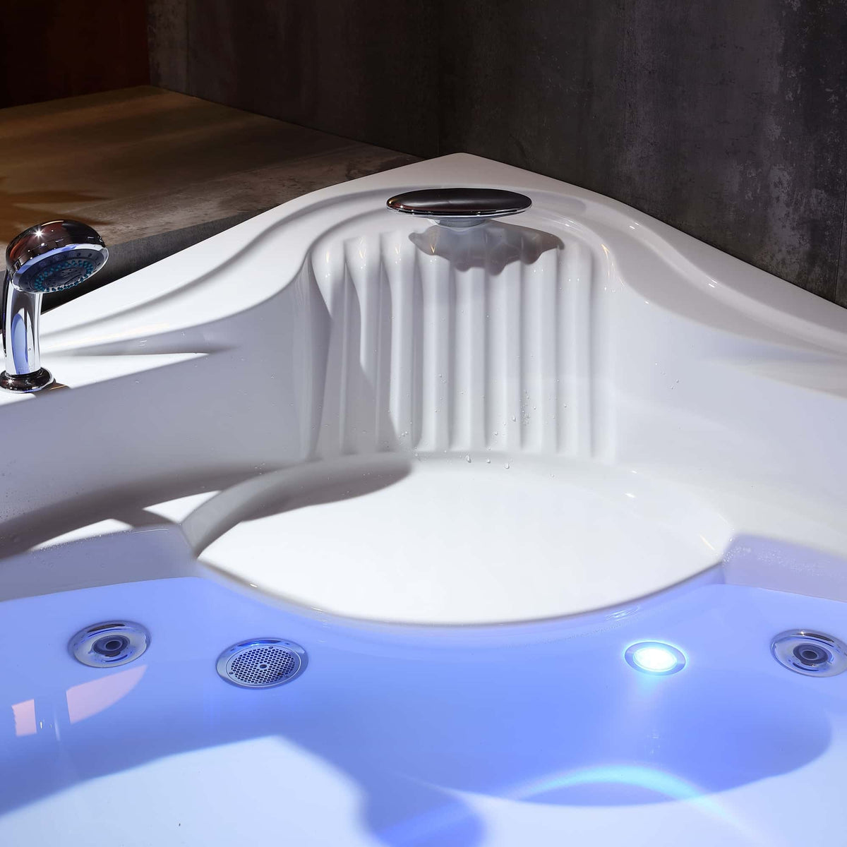 Corner whirlpool bathtub interior with water jets and blue LED floor light