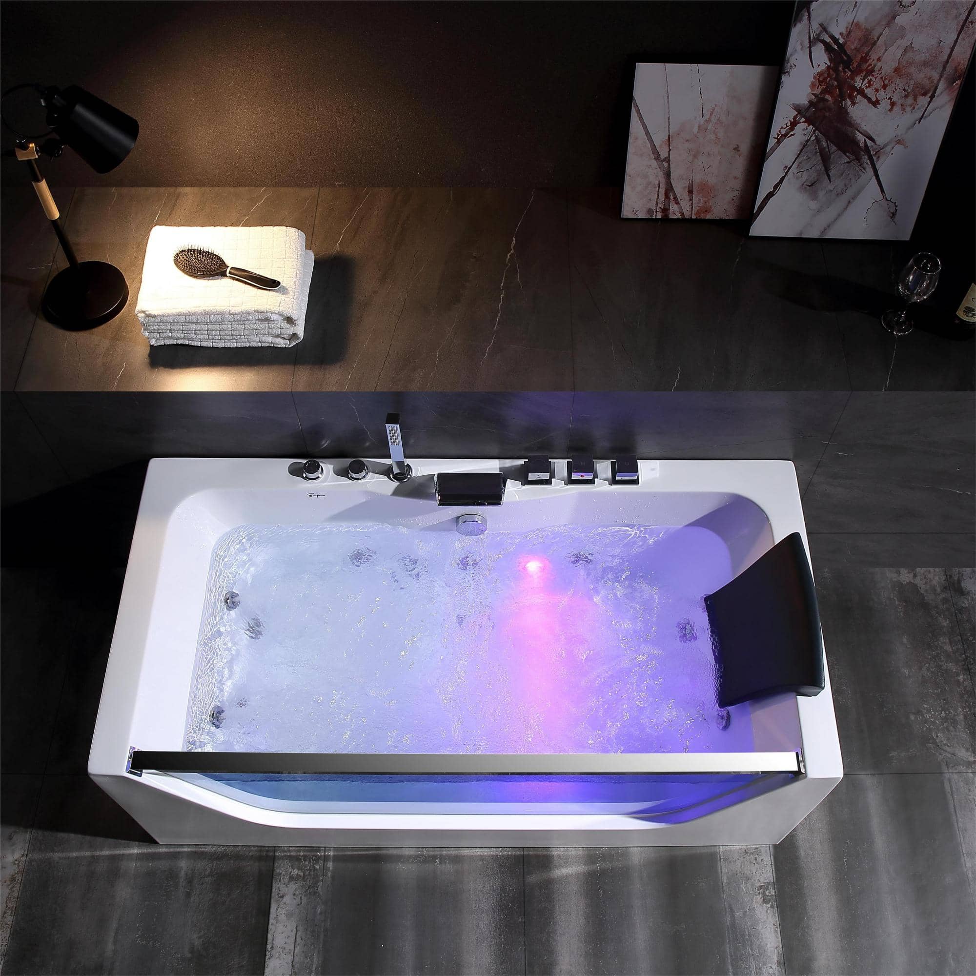 Rectangular whirlpool bathtub with glowing LED interior and chrome faucet controls