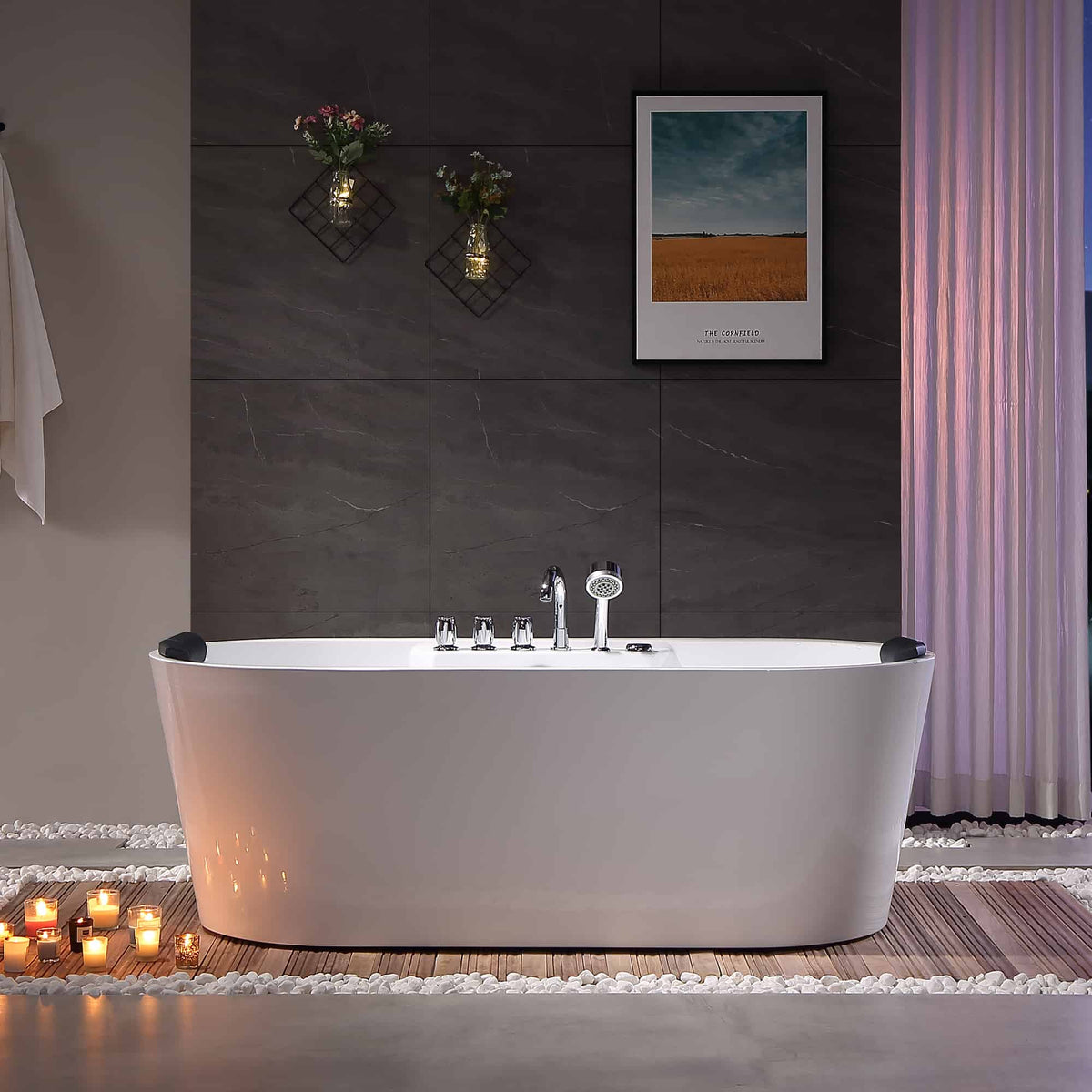 White freestanding acrylic whirlpool bathtub with chrome faucet set and front view.