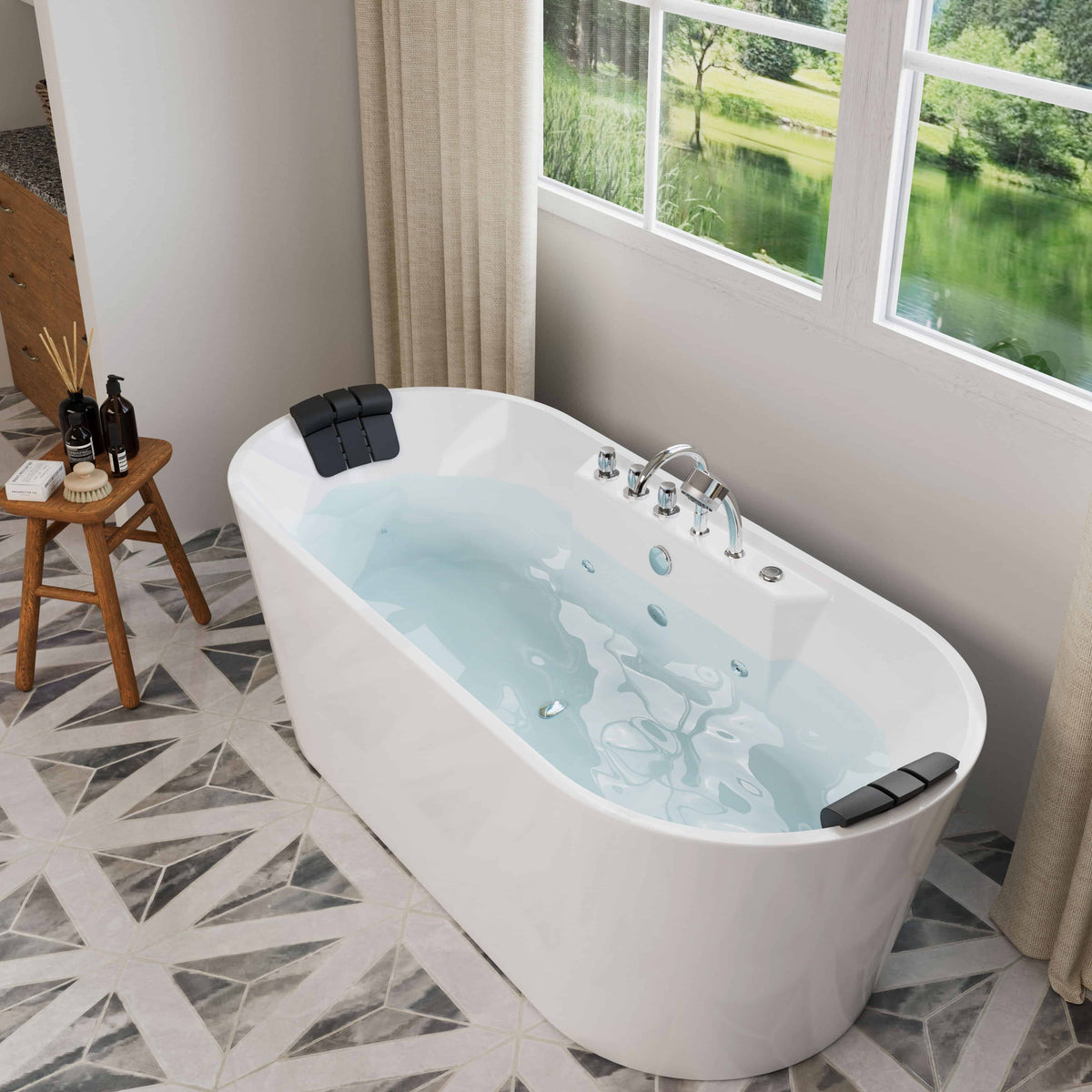 White freestanding acrylic whirlpool bathtub with chrome controls and blue whirlpool water.