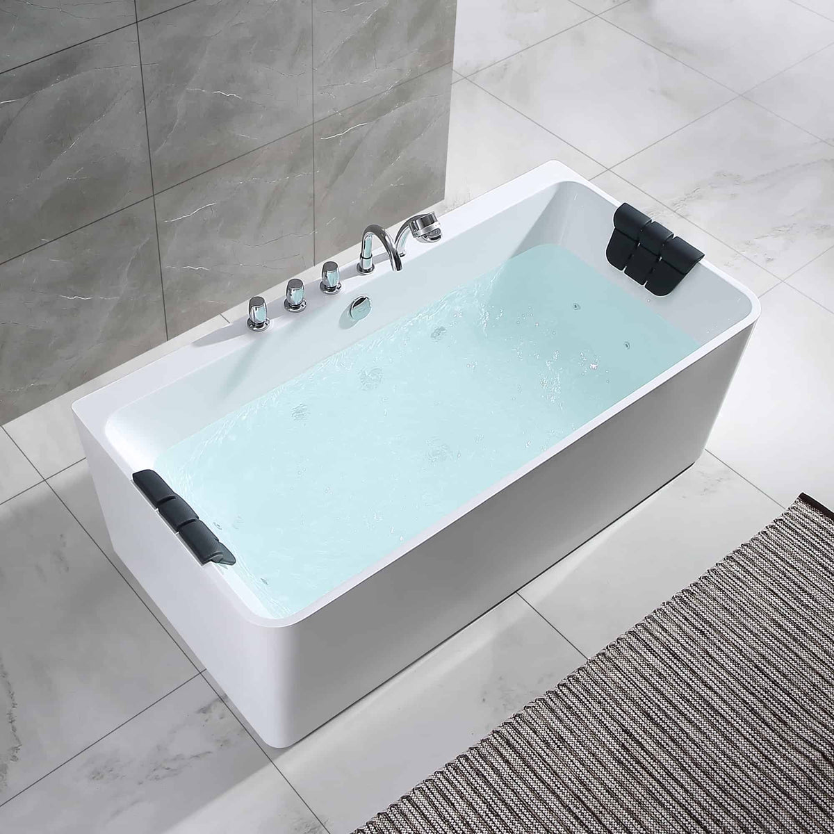 White acrylic whirlpool bathtub with light-blue water and black handle accents