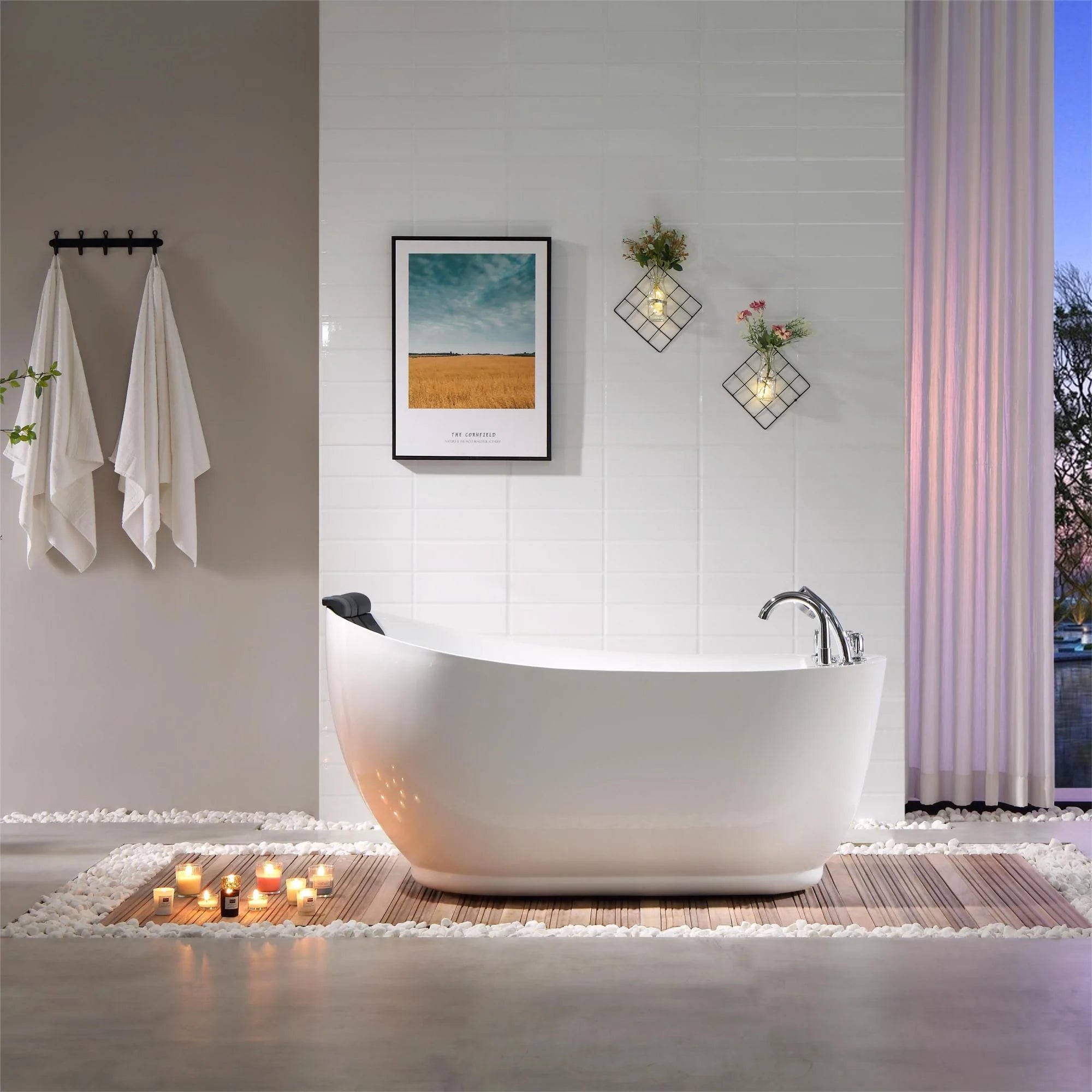 Freestanding acrylic bathtub with white finish, chrome faucet, and black headrest detail.