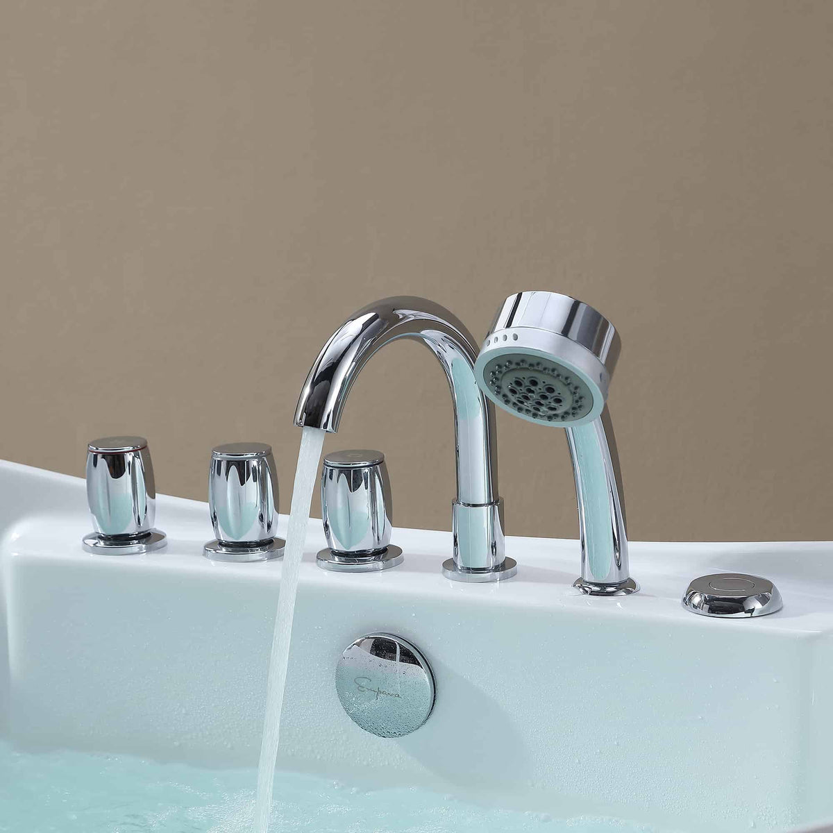 Close-up of chrome bathtub faucet and handheld showerhead over white acrylic tub.