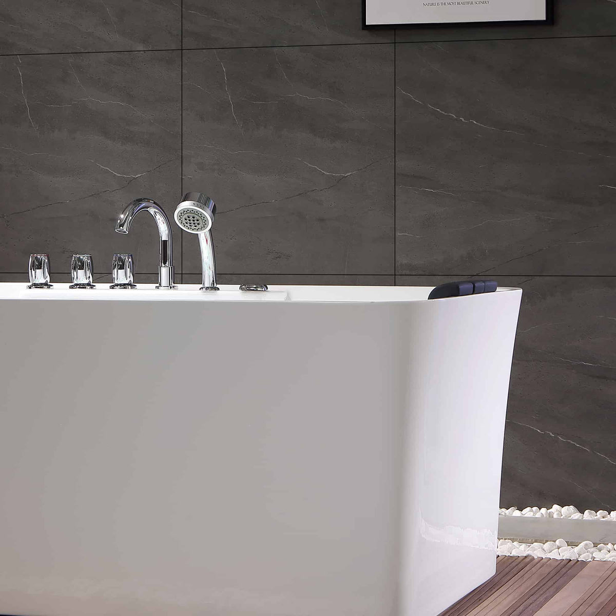 Close-up of freestanding white whirlpool bathtub rim with chrome faucet and faucet controls