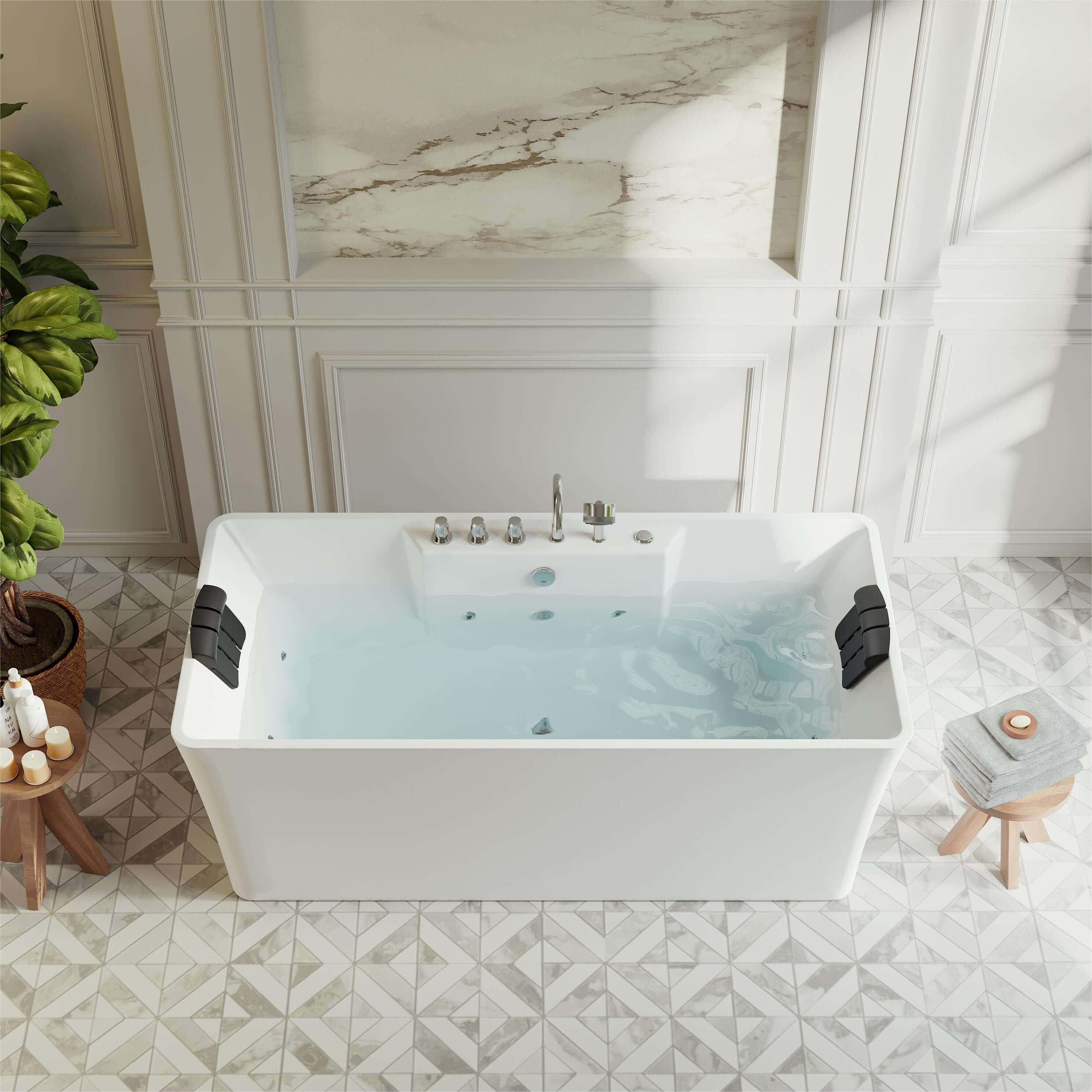 Freestanding white acrylic whirlpool bathtub with chrome faucet and visible jets