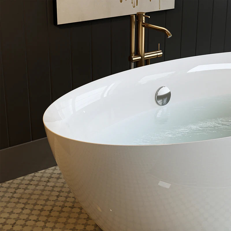 White freestanding soaking tub with center drain, chrome faucet, partially filled