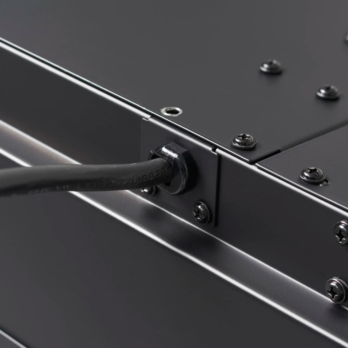 Linear electric fireplace control panel detail with brushed metal trim and screws