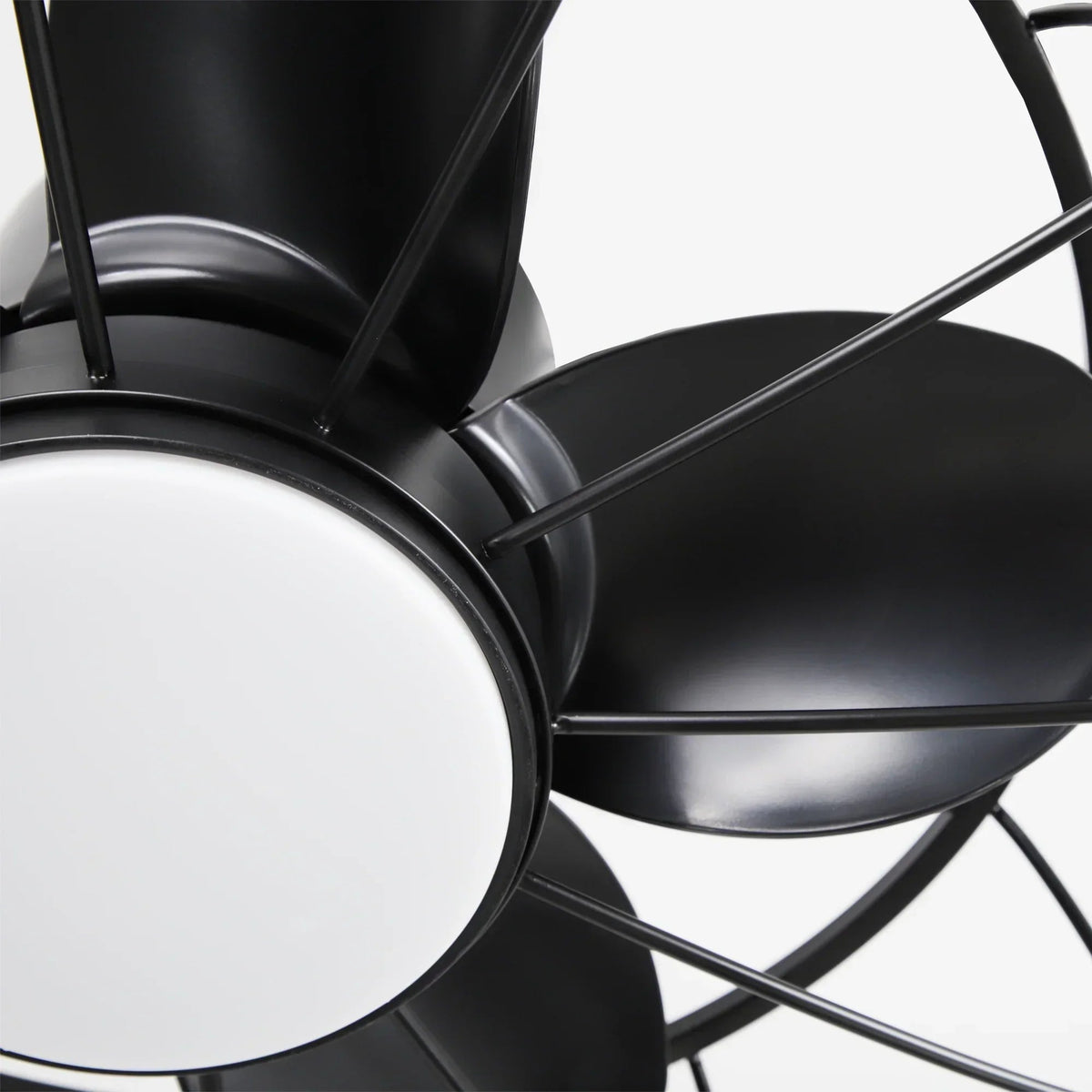 Black ceiling fan motor housing with curved fan blades and circular light panel