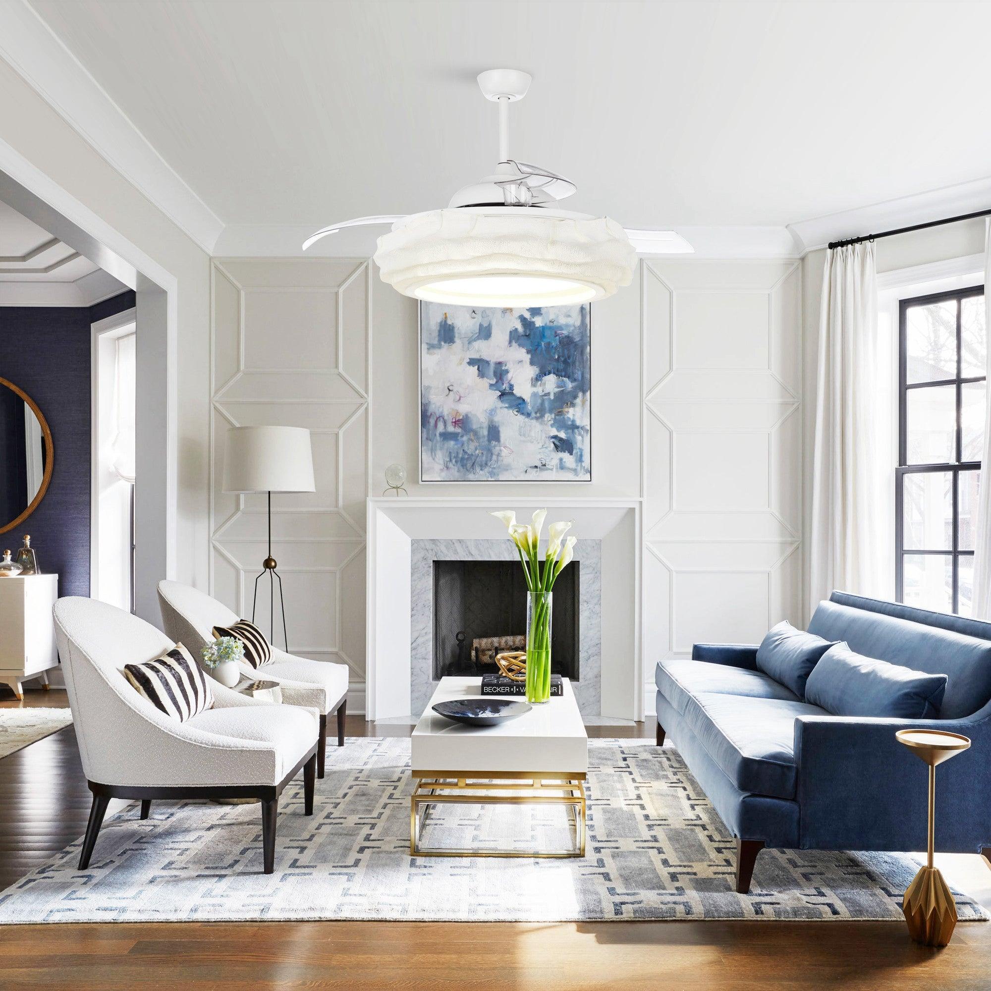 White ceiling fan with LED light in bright living room, fabric-look blades and clear housing
