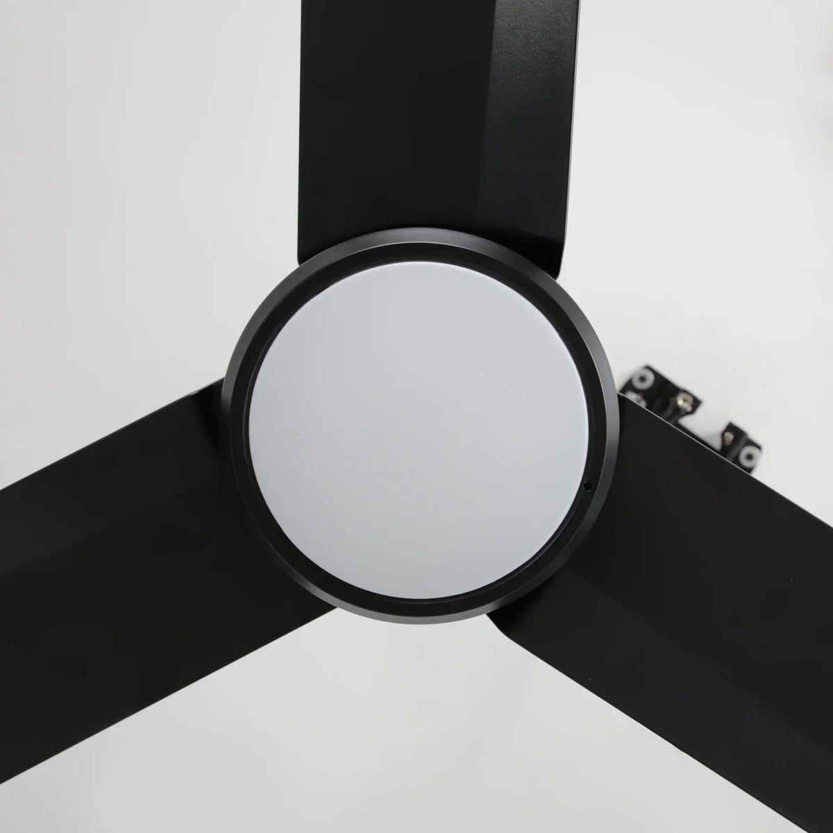 Black ceiling fan blade hub with circular LED light ring and blade attachment screws