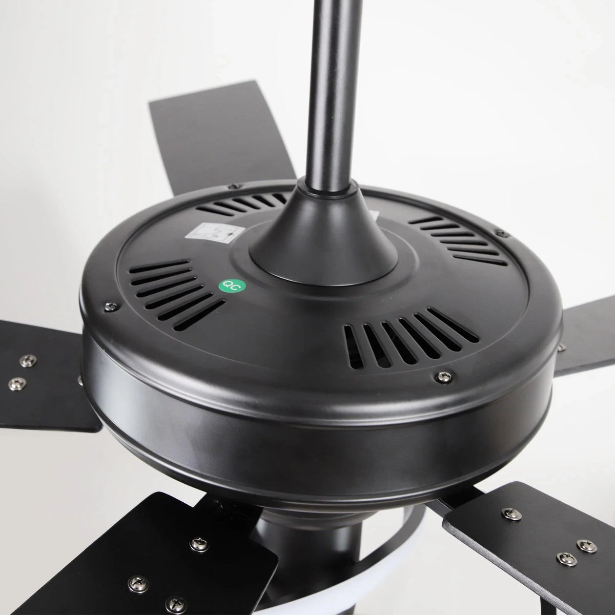 Black ceiling fan motor housing with vented base and central downrod