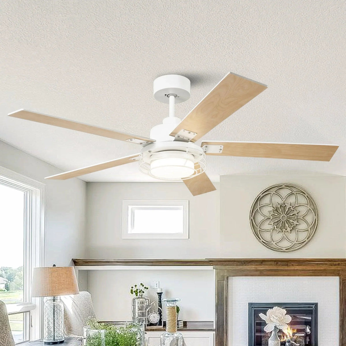 Ceiling fan with light wood blades and white motor housing in a living room