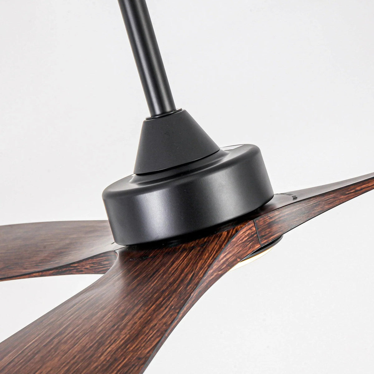 Black ceiling fan downrod and motor housing with wood blade near
