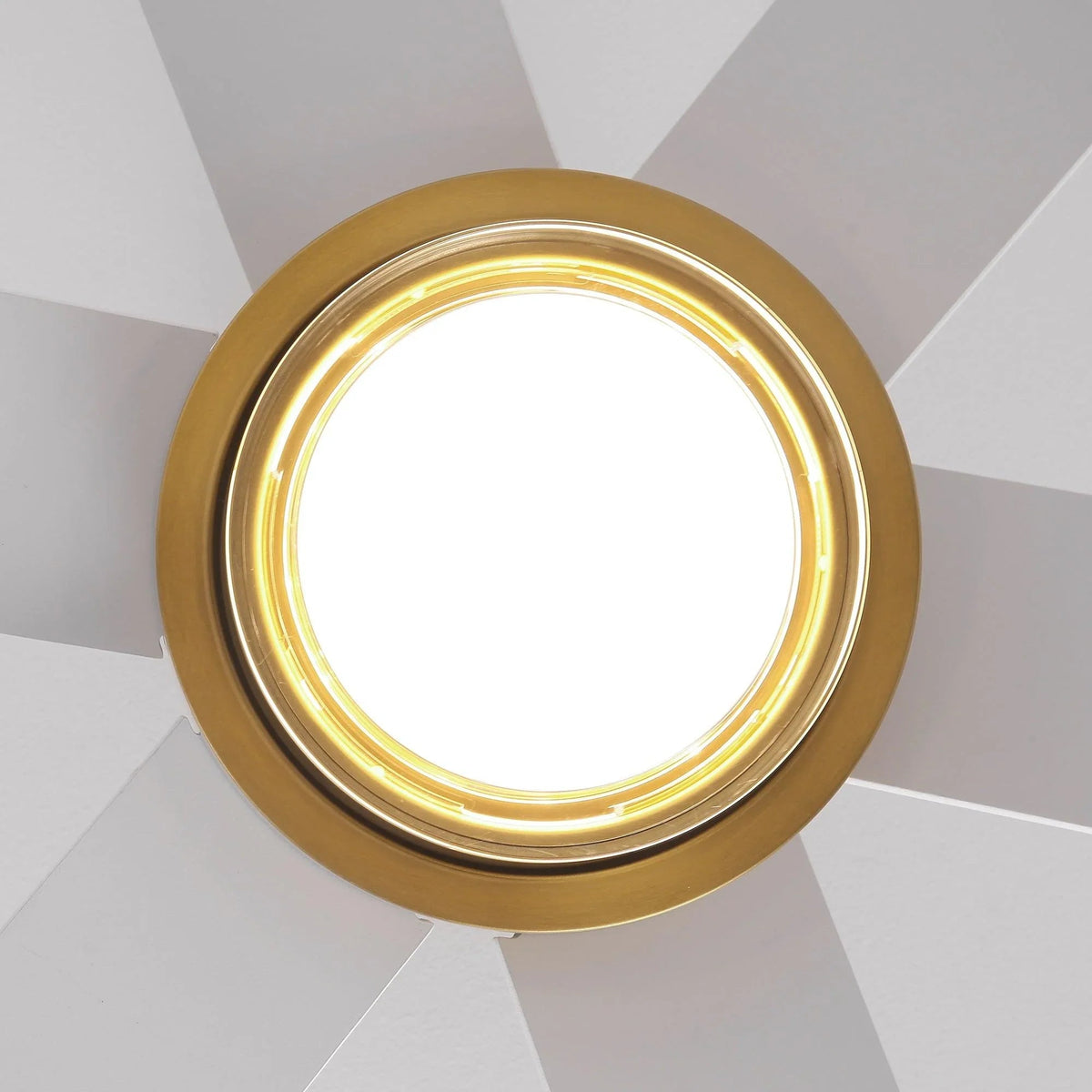 Golden LED light ring on modern ceiling fan, glowing white