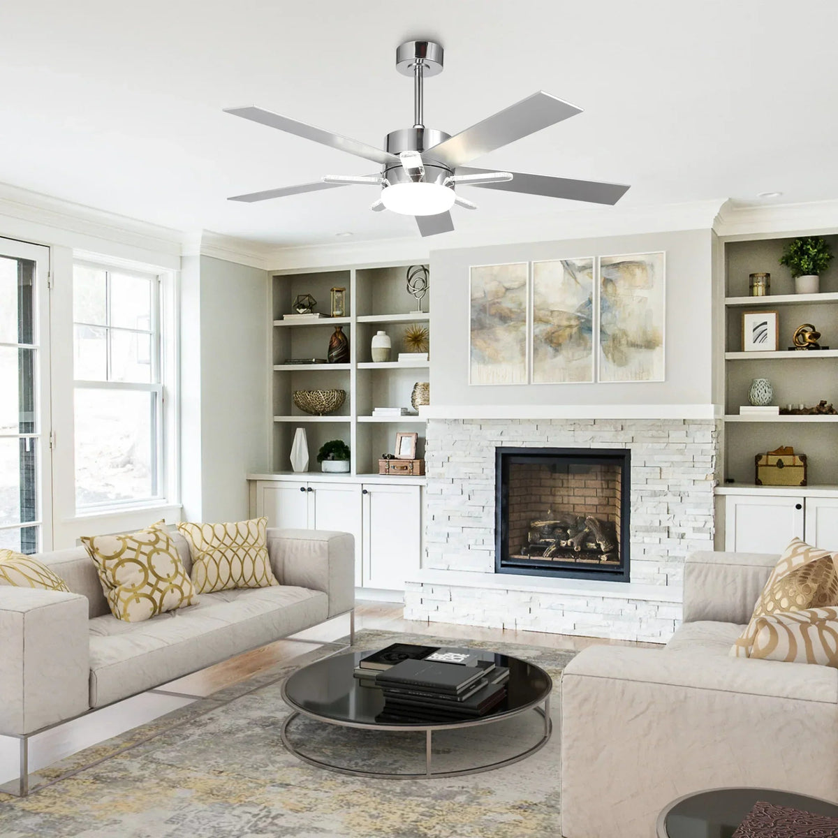 Chrome ceiling fan with reversible blades and LED light mounted on ceiling.
