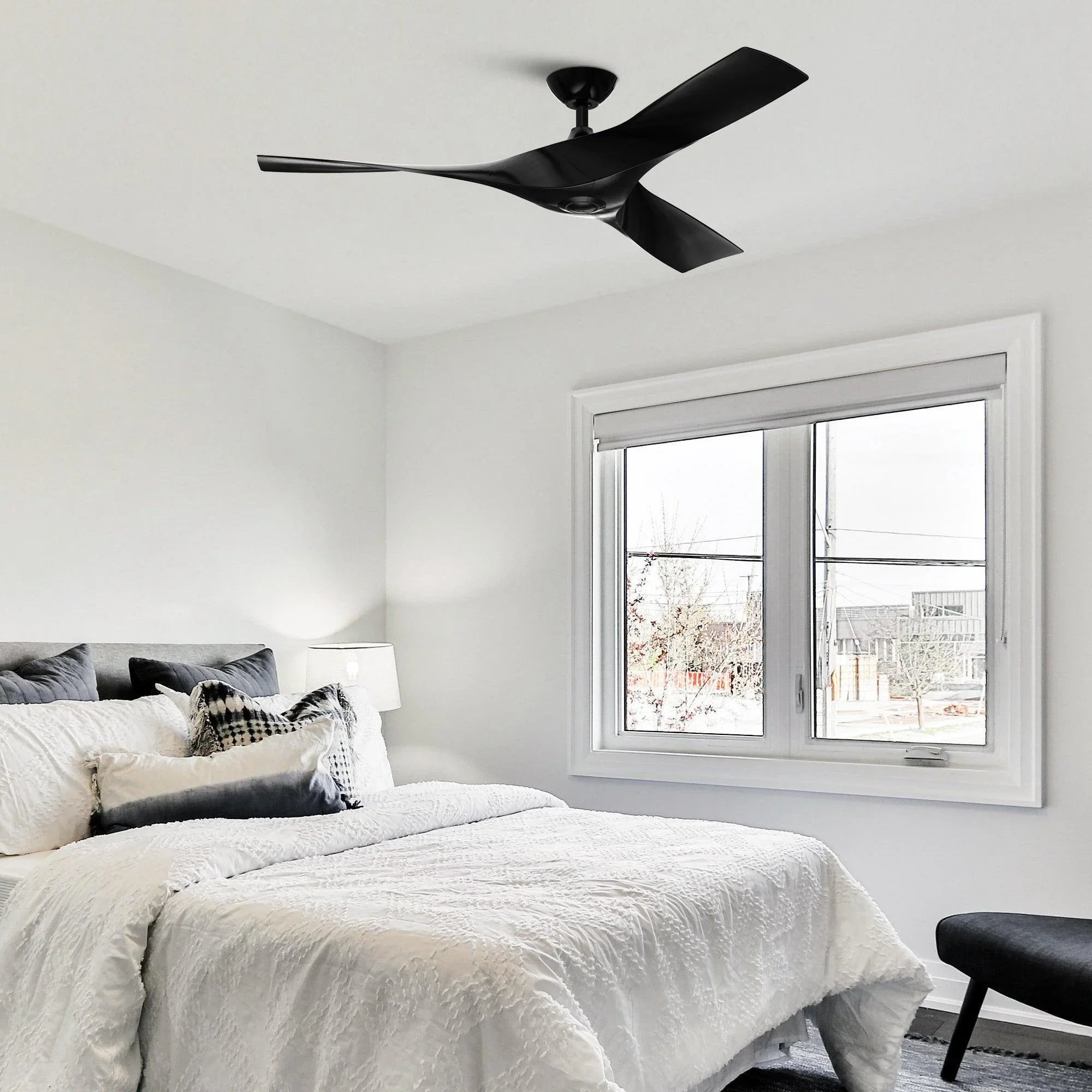 Black industrial ceiling fan with three blades and downrod mount, installed on ceiling