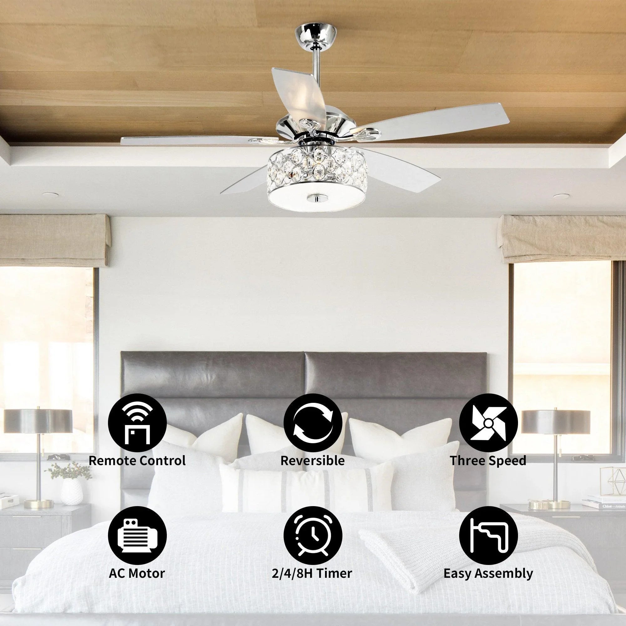 Chrome ceiling fan with crystal lamp light and silver blades above a bed
