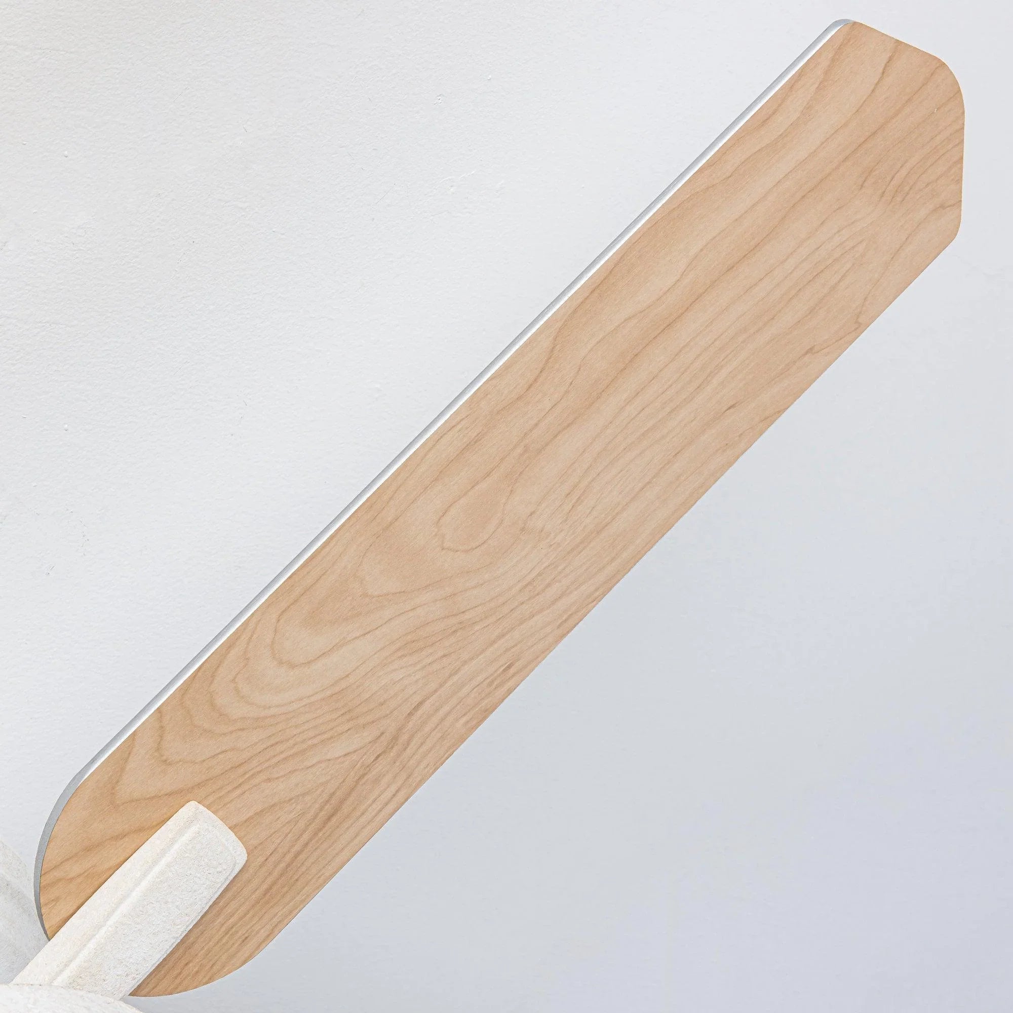 Flush mount ceiling fan blade and white motor housing in light wood finish