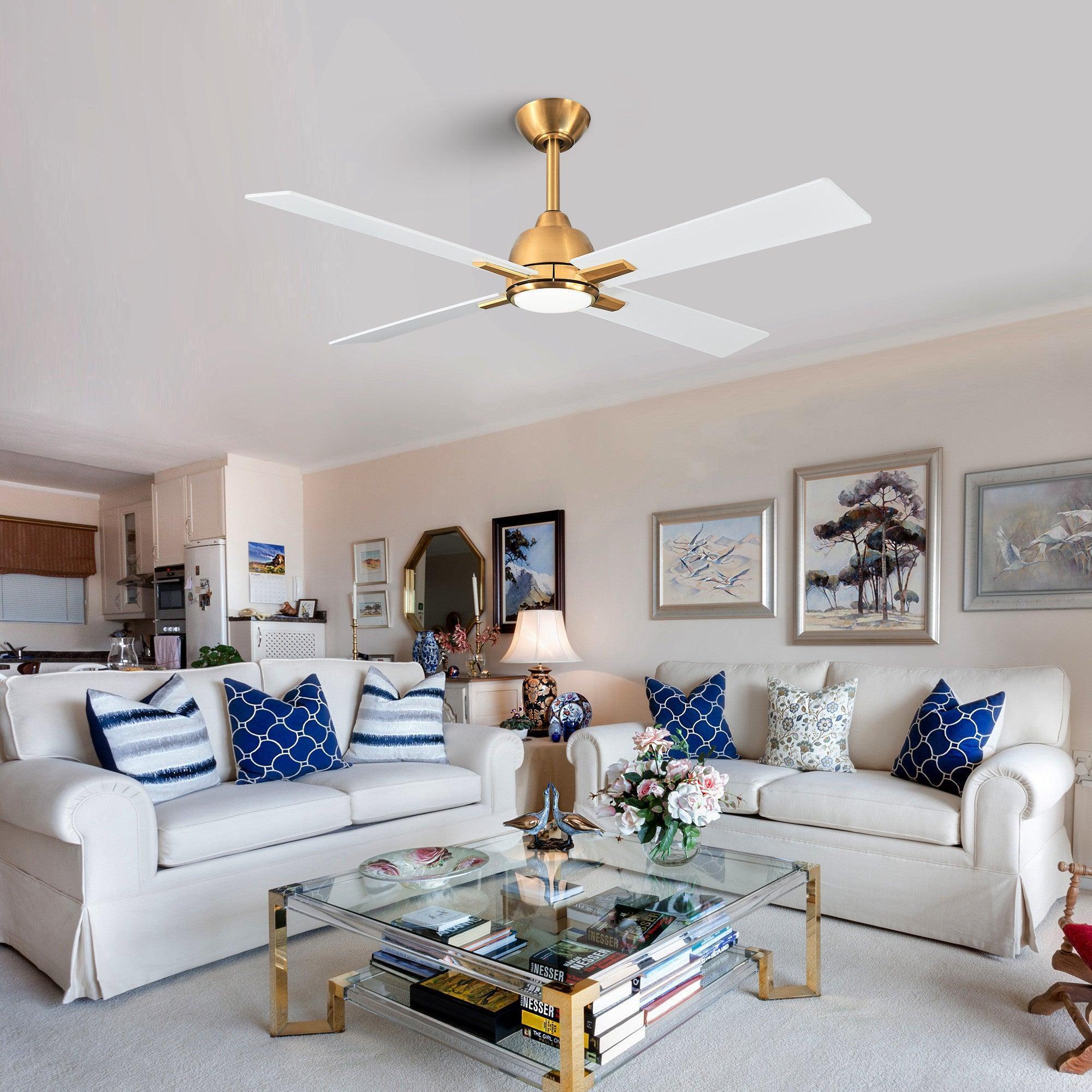 Golden reversible ceiling fan with white blades and light in a living room