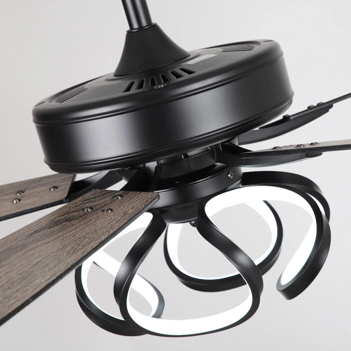 Ceiling fan motor housing with black trim and three white glass light shades