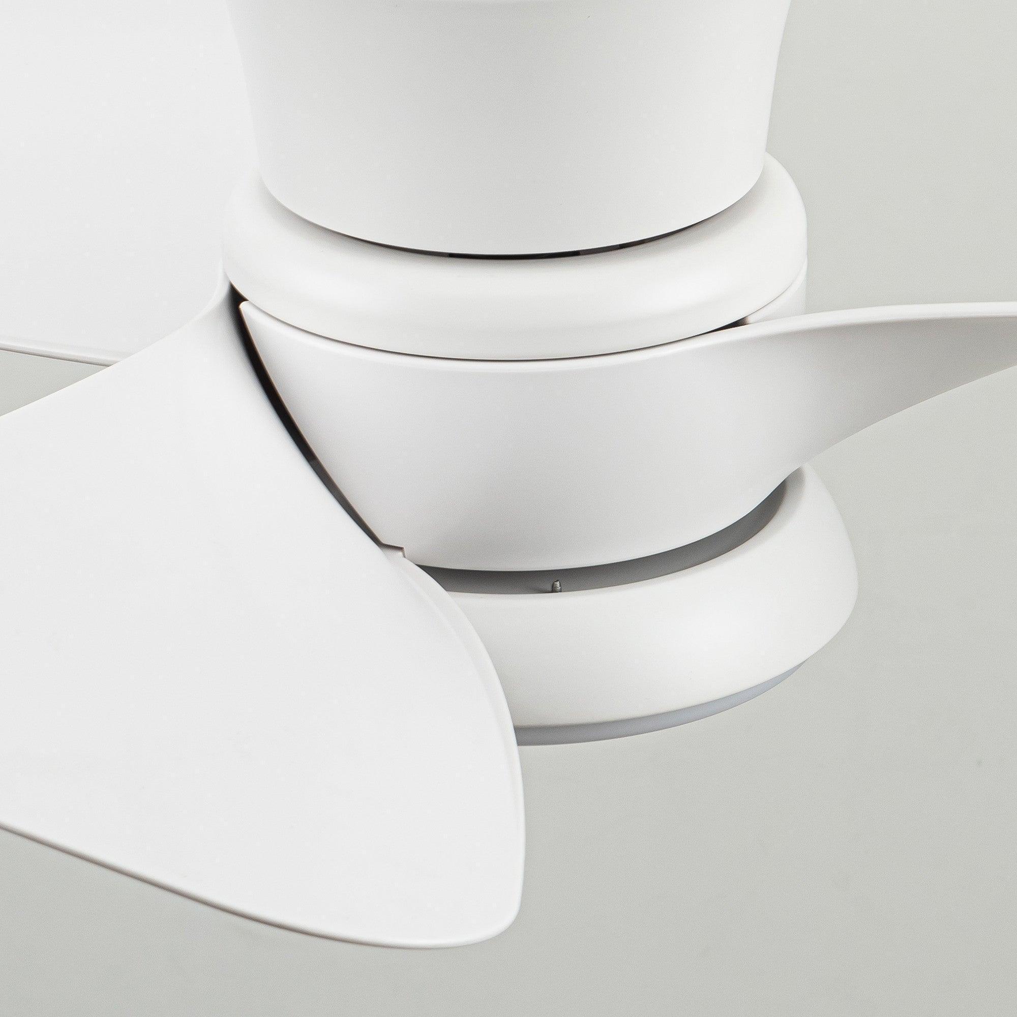 Close-up of white ceiling fan blade attachment and flush light housing.
