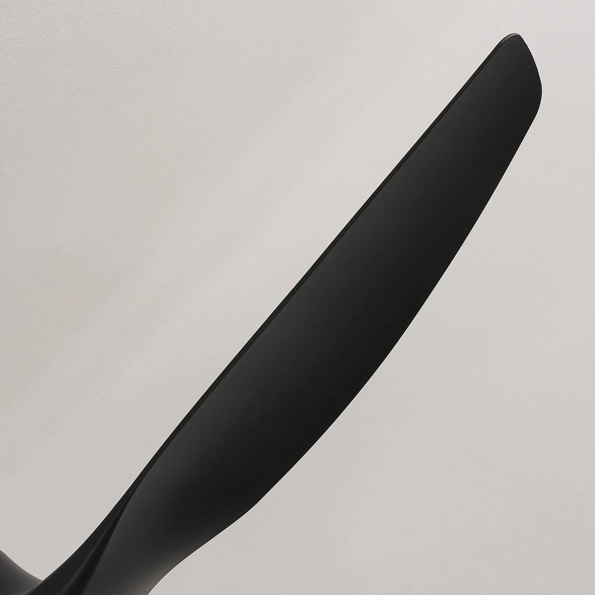 Close-up of a dark ceiling fan blade with smooth matte finish
