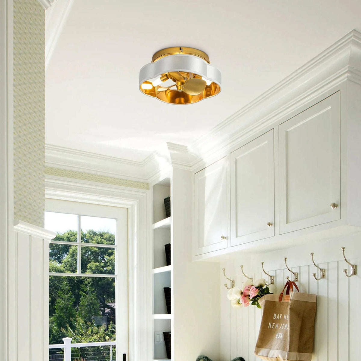 Golden flush mount ceiling fan with light installed on ceiling in a room, blades visible