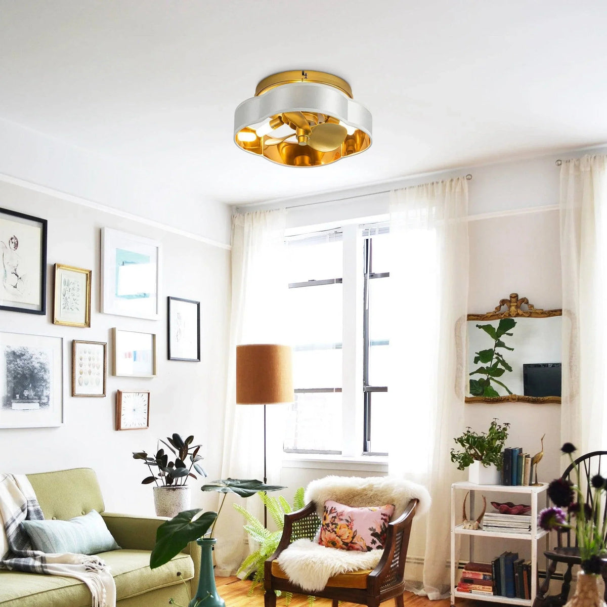 Golden flush mount ceiling fan with light centered above living room, white outer shade visible
