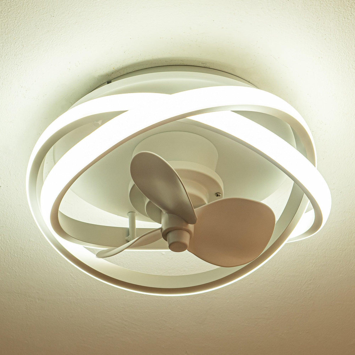 White flush-mount ceiling fan with illuminated ring, caged frame, and 3 blades