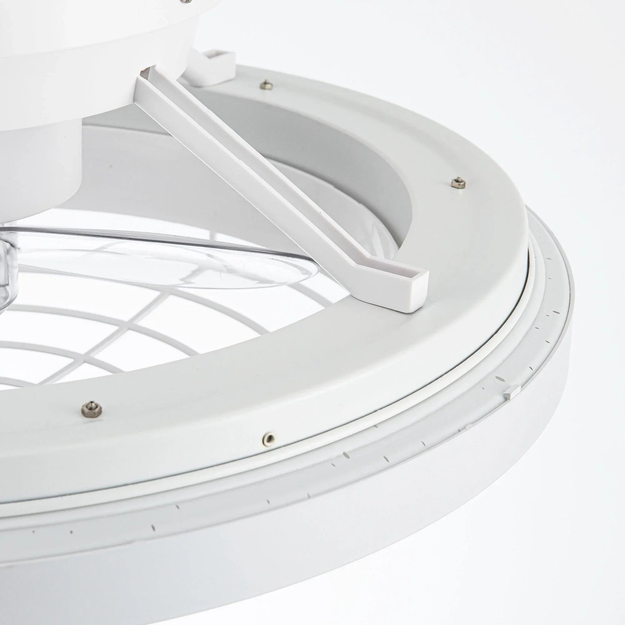 White ceiling fan interior view with blade arm support and outer ring housing.