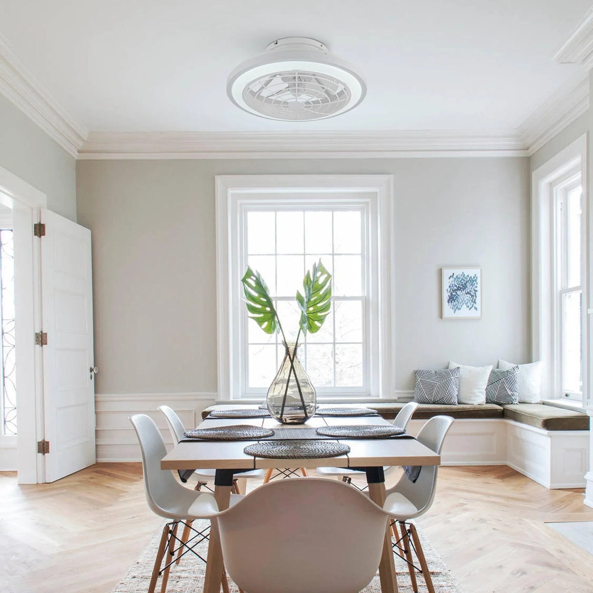 White flush-mount ceiling fan with integrated light installed on the ceiling