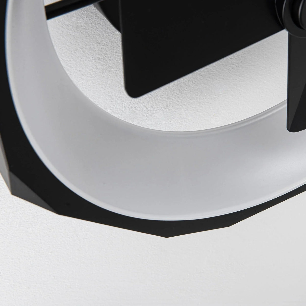 Black flush mount ceiling fan close-up of light ring and blade edge