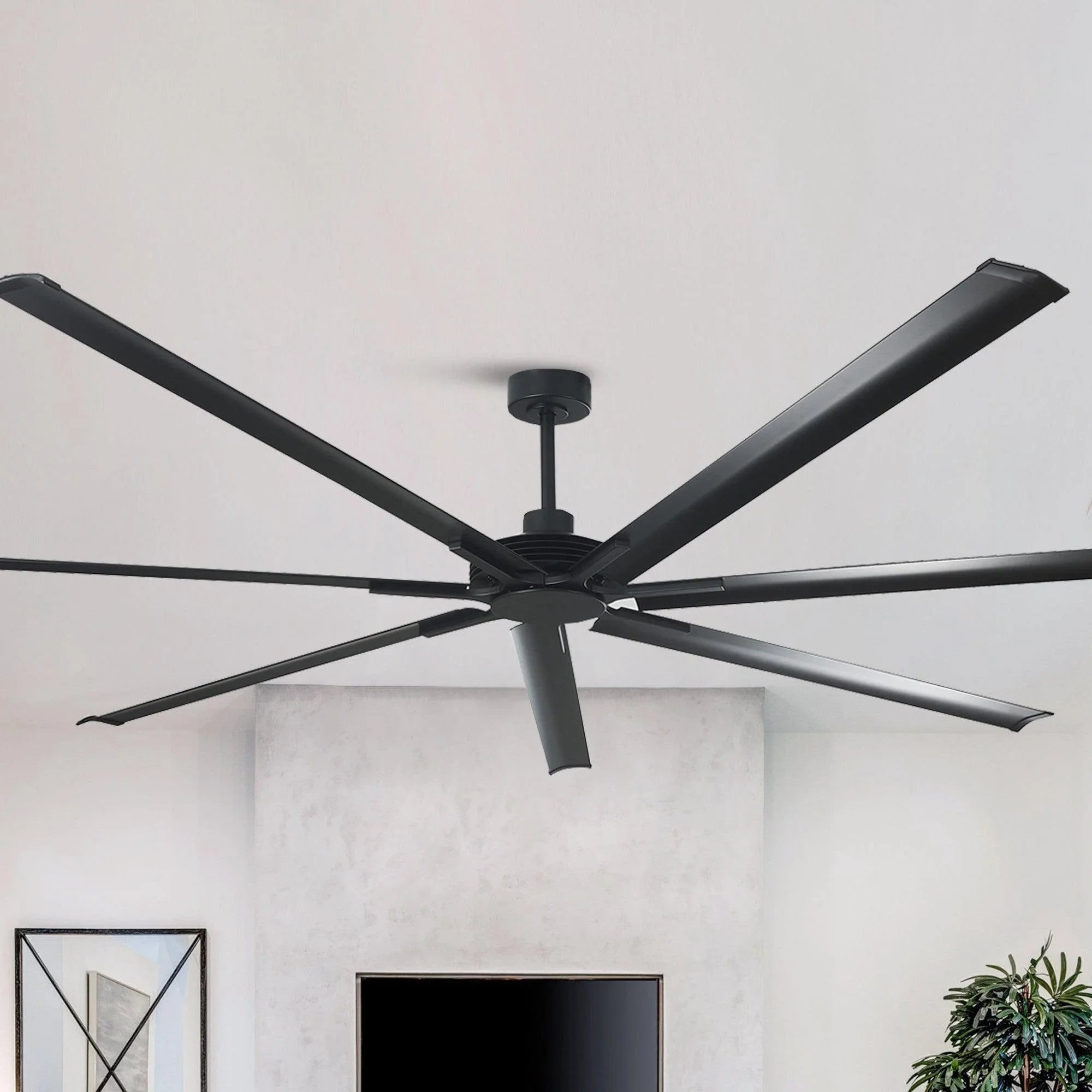 Black ceiling fan close-up with multiple blades and central motor housing