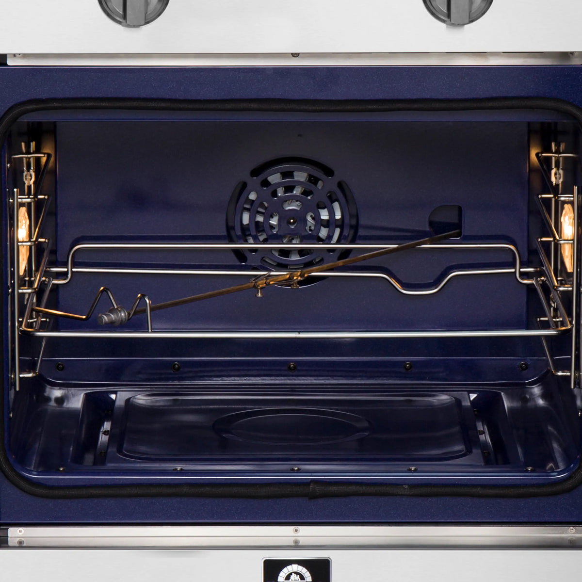 Interior oven cavity with fan vent, upper heating elements, and back-wire rack