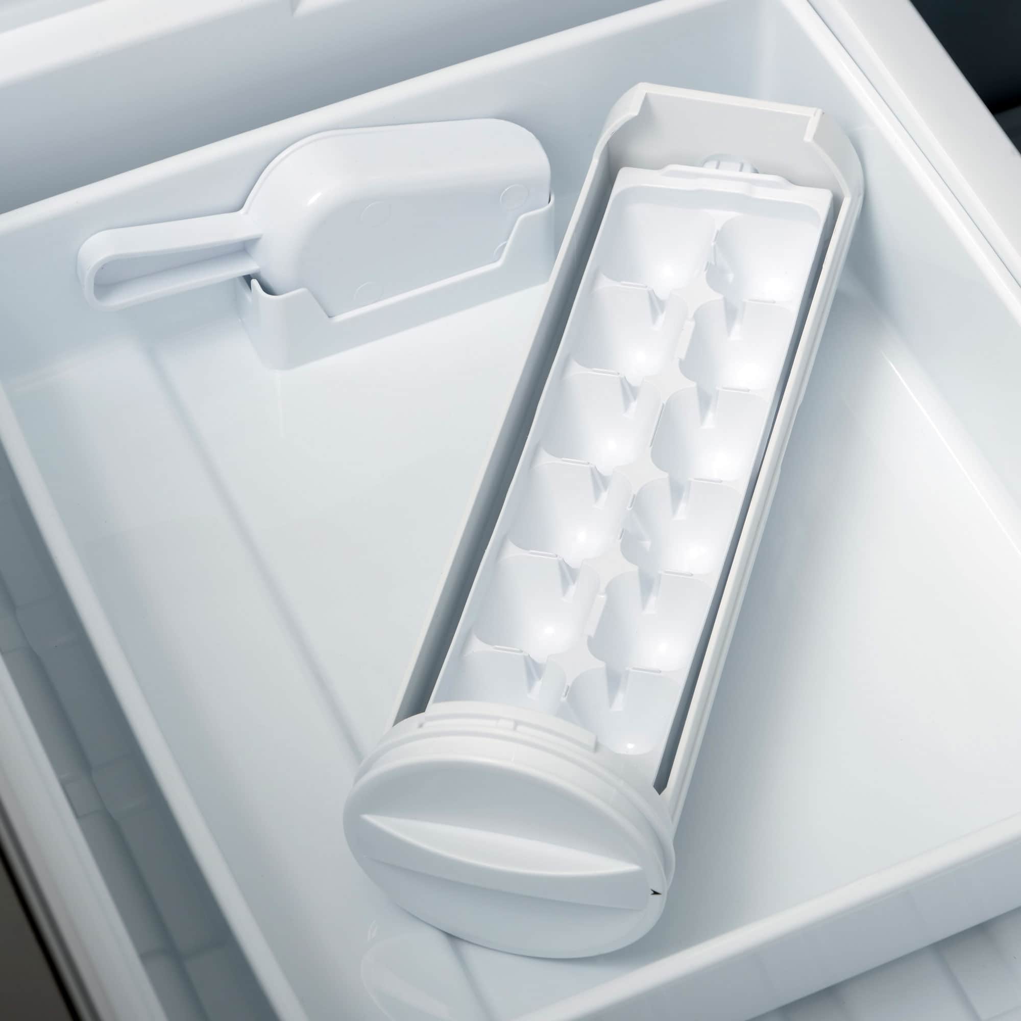 Ice maker bin in freezer drawer with molded ice cube compartments