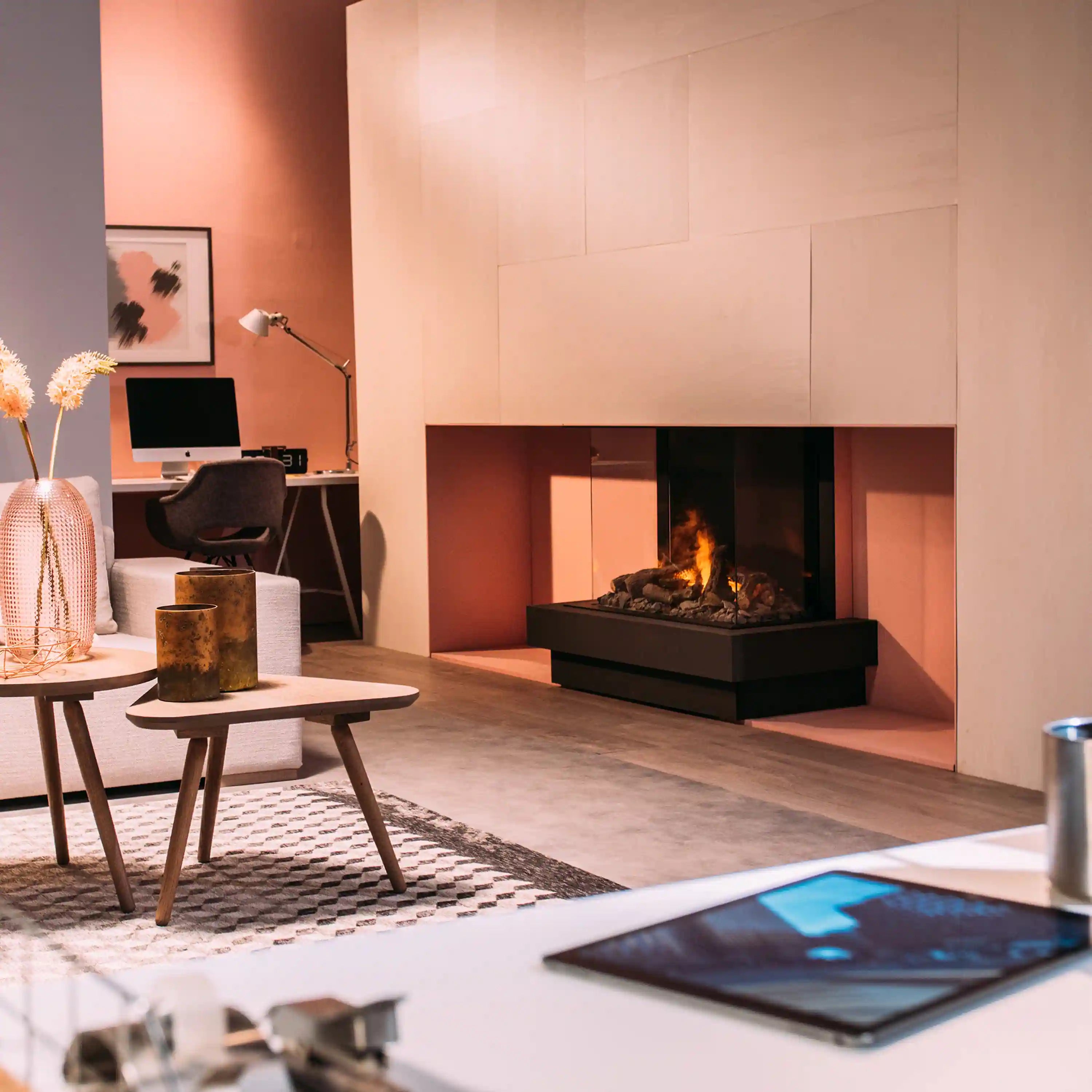 Built-in electric fireplace with three-sided flame view and black base surround