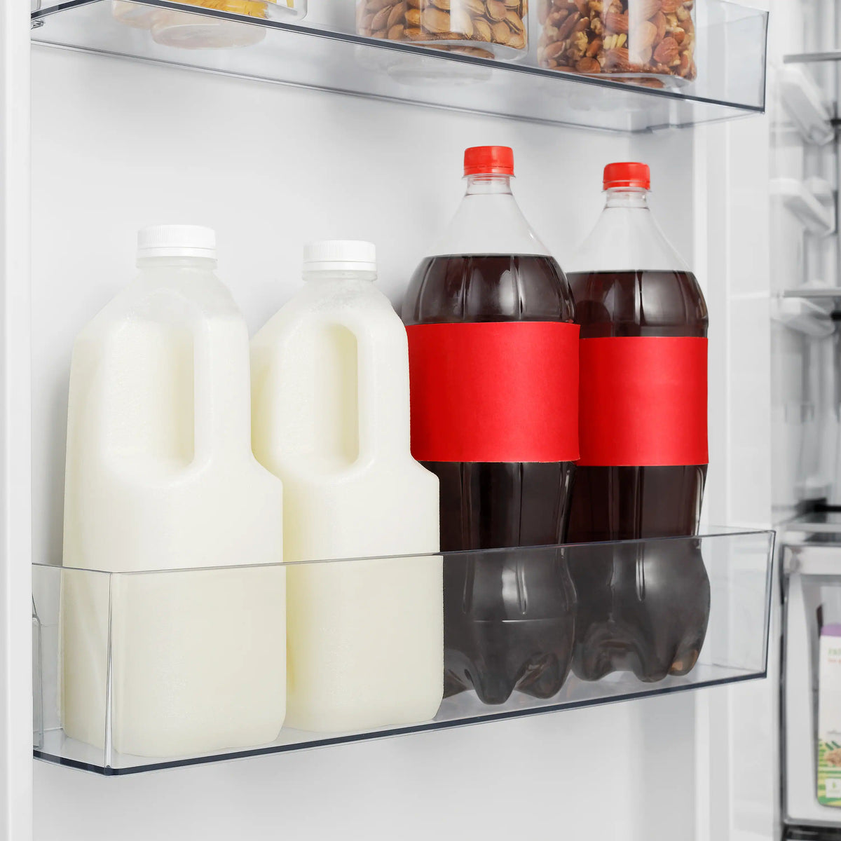 Built-in refrigerator door shelf with bottled beverages in clear bin