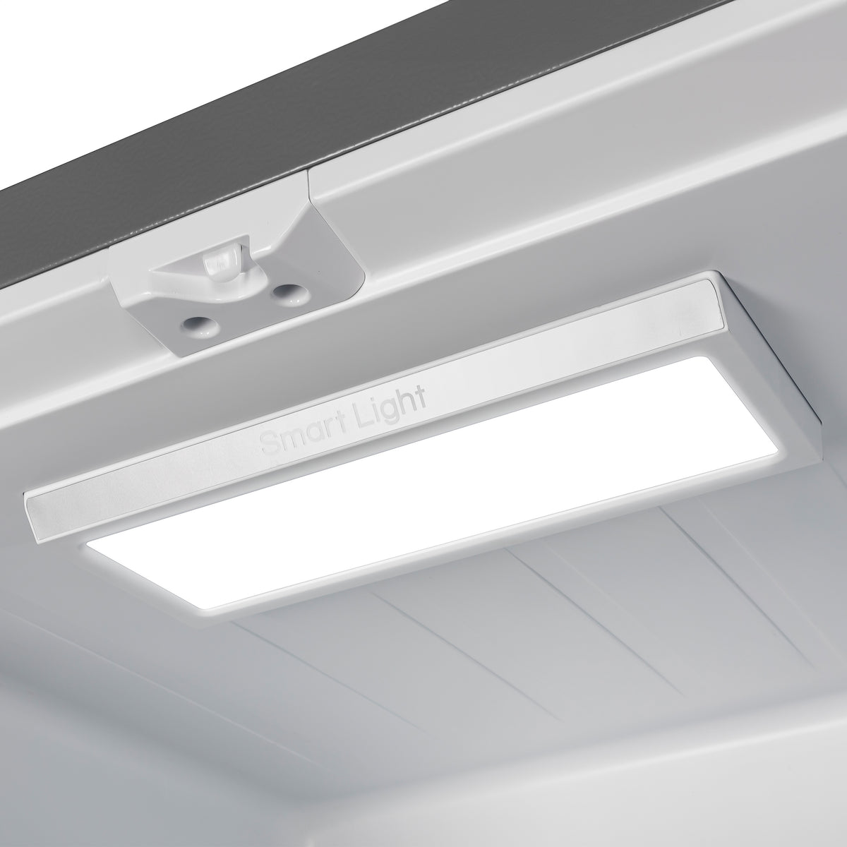 Refrigerator interior light bar under the freezer compartment cover